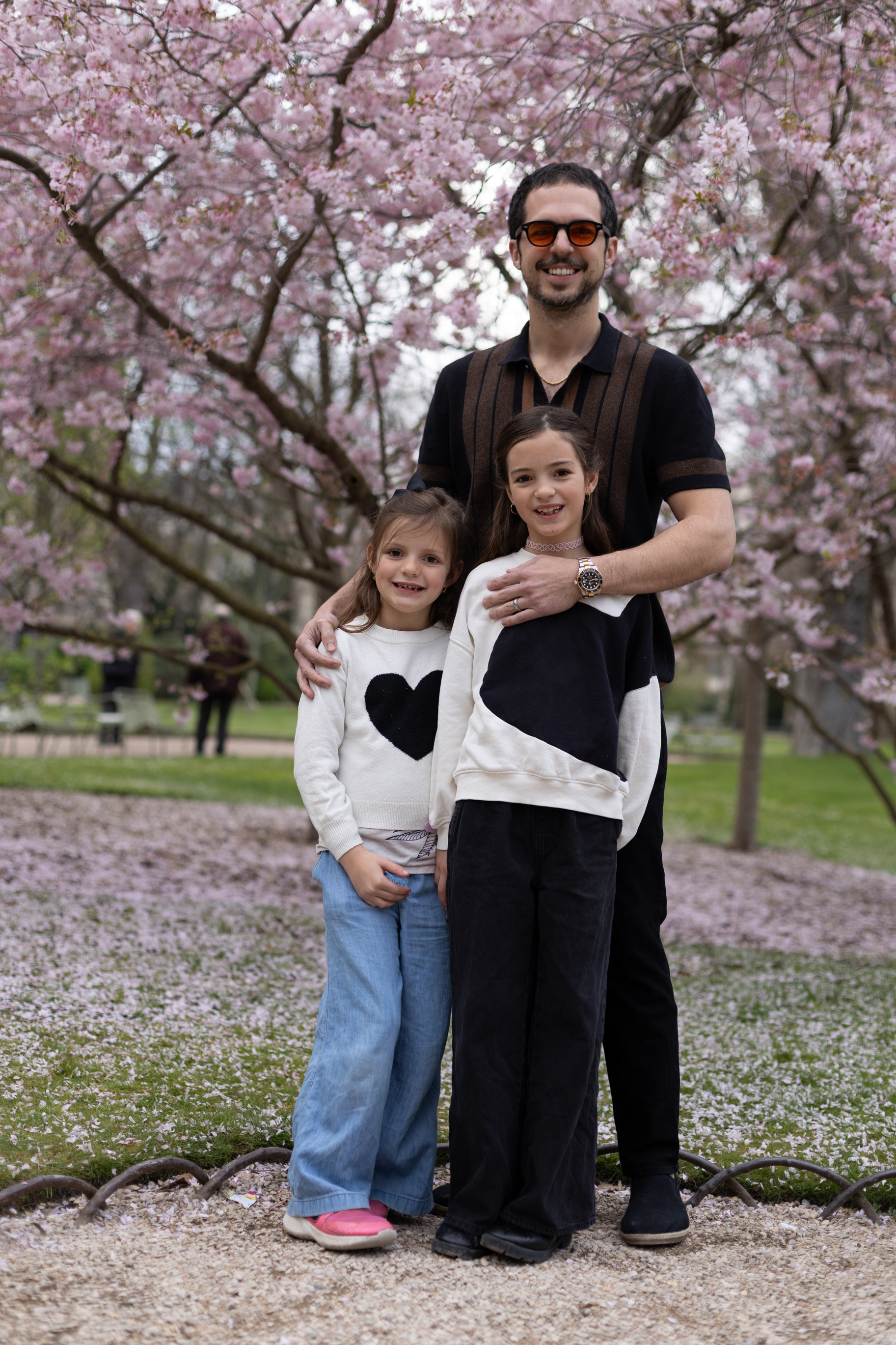 Professional portrait of a family of 3 on a sunny spring day in Paris.