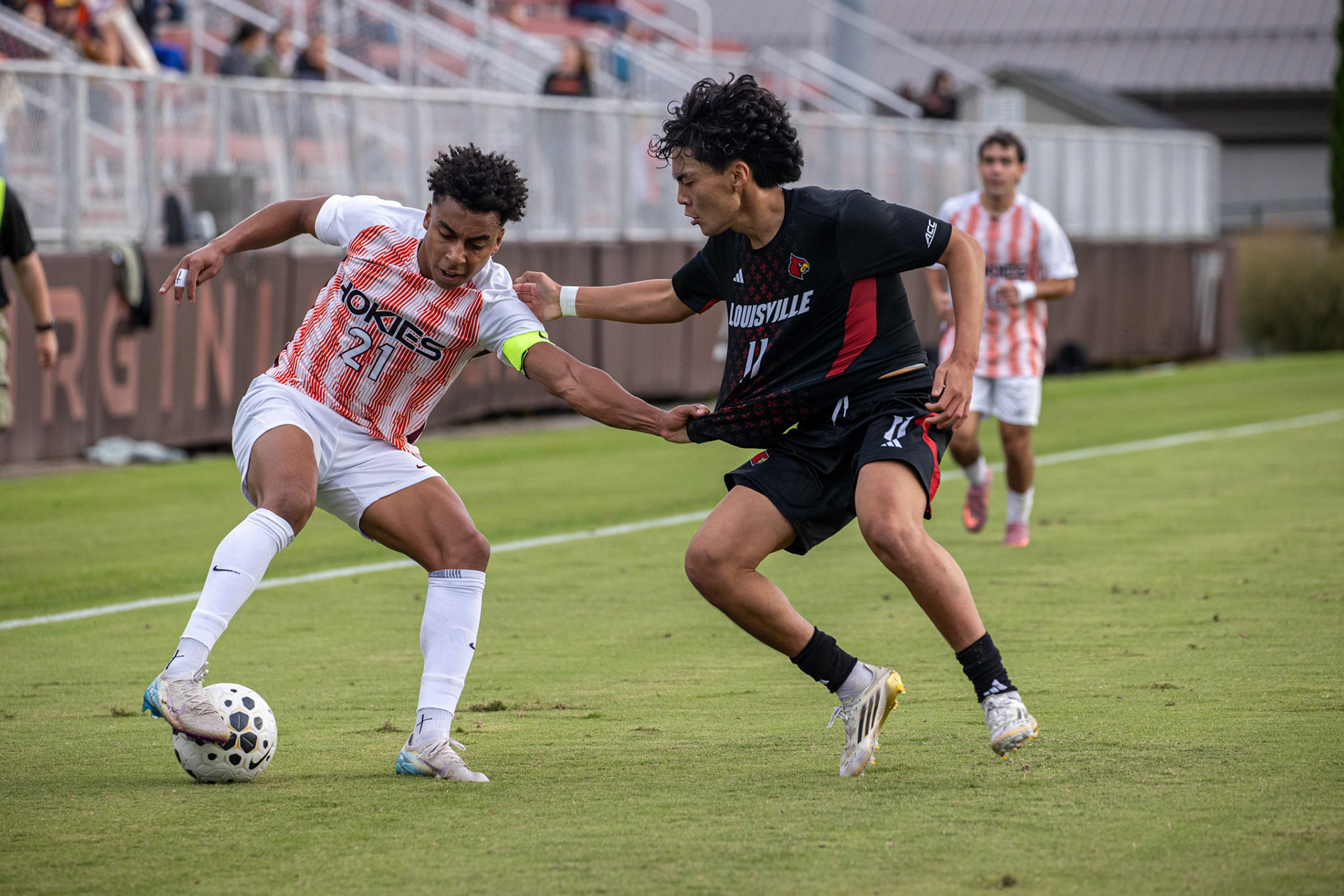 Virginia Tech winger Noe Uwimana (21) attempts to beat a Louisville defender