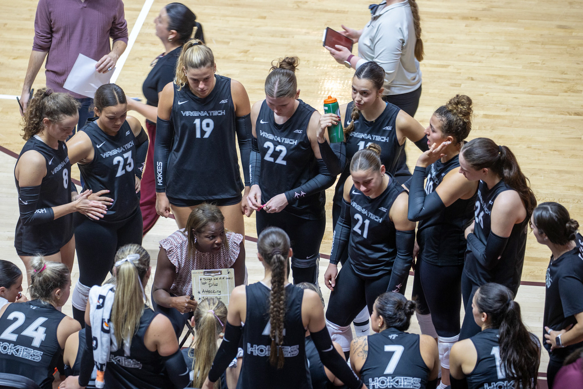 Head Coach Marci Byers walks her team through the game plan during a timeout