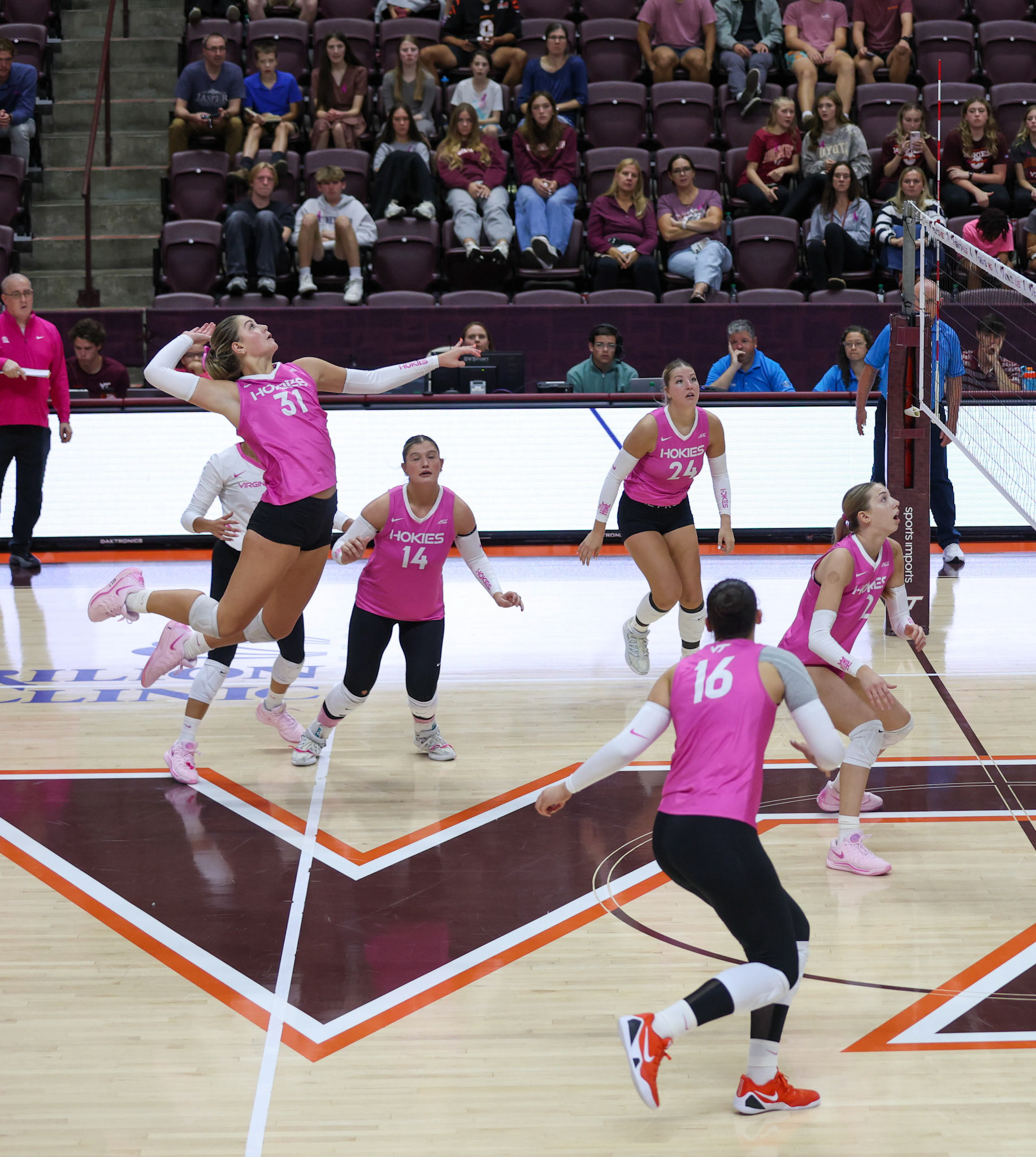 Outside hitter Payton Woods (31) elevates for a powerful spike