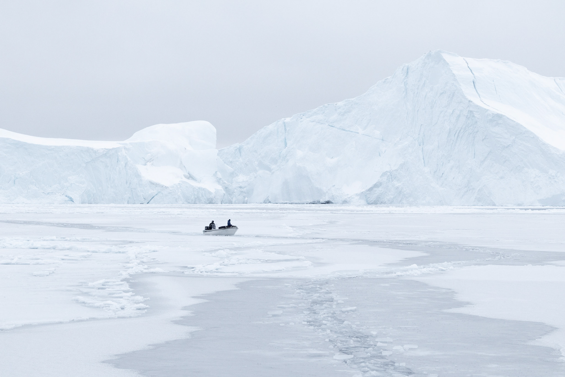 Fishing boat edging through ice.