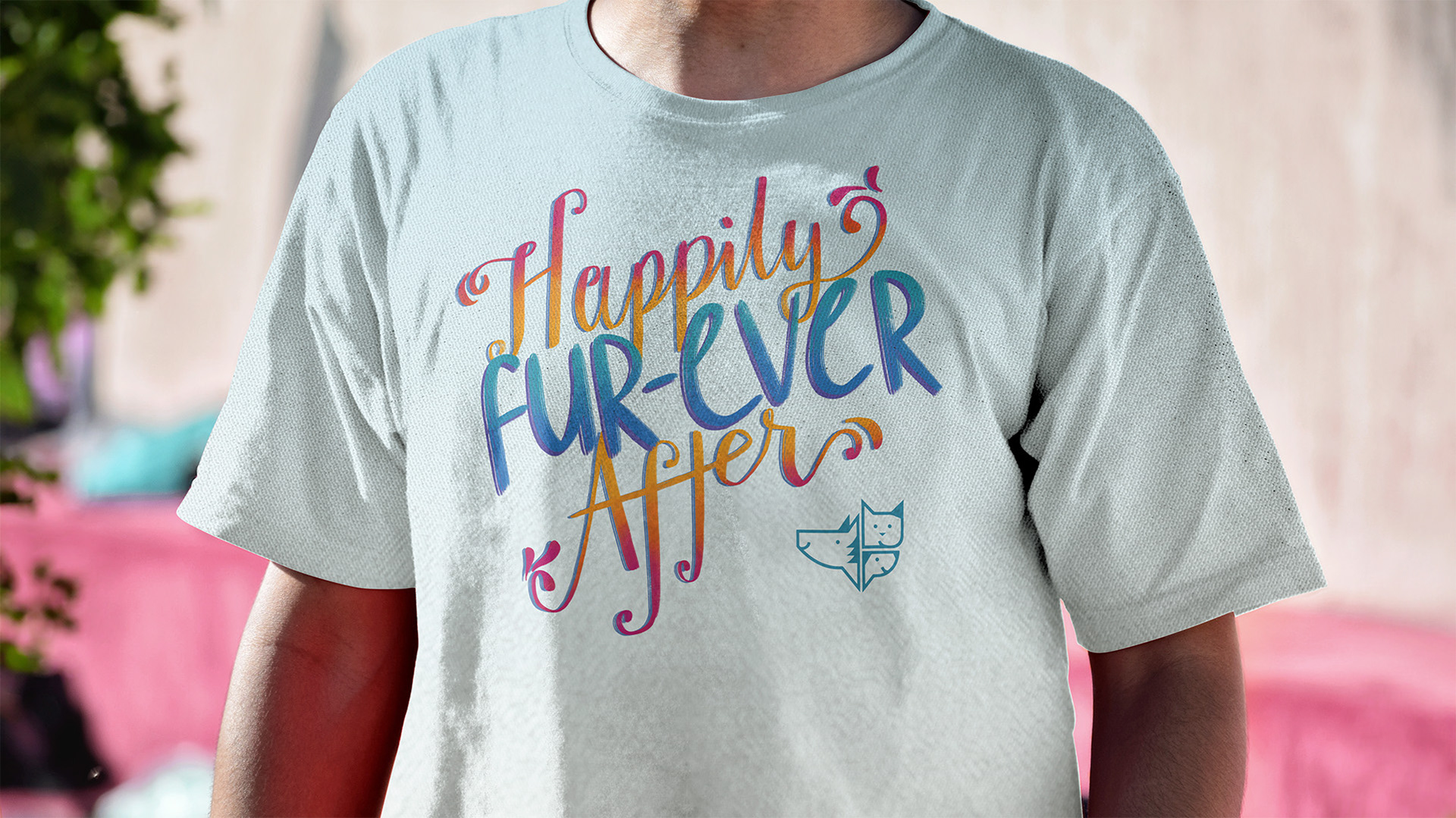 Man wearing a t-shirt reading "Happily Fur-Ever After" with the HSNT logo.