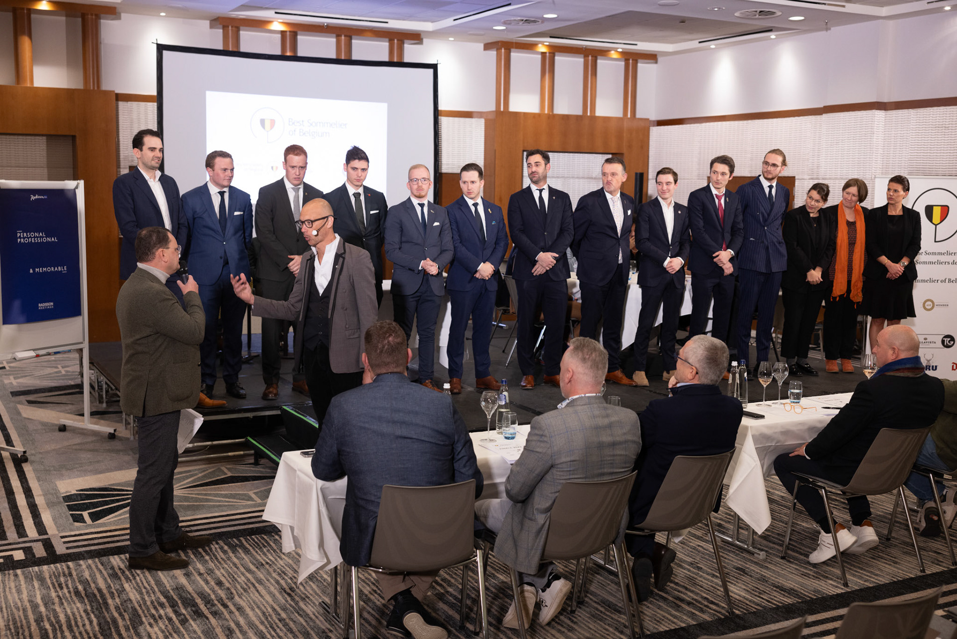 20231112 ANTWERP, BELGIUM Radisson Blu Astrid Hotel, final Best Sommelier of Belgium. Three candidates emerged from a pool of 14 in the semi-final, and the finalist is yet to be (-)After six practical tests that assessed participants' extensive knowledge, craftsmanship, and ability to handle stress, it was revealed that ……….. emerged as the ultimate winner. Employed at restaurant …………, ……….. will proudly carry the title not just for this year but throughout his entire professional career, as the title is a one-time achievement. The annual competition is organized by the Belgian Sommeliers Guild, with a distinguished jury comprising influential figures from the wine industry, past winners, and international members. This official title, unlike various commercial initiatives, not only comes with a trophy, valuable prizes, and enduring recognition but also opens doors for the winner to compete in European and World Championships. These global competitions are organized by ASI (Association Sommeliers International), currently led by the Belgian William Wouters.