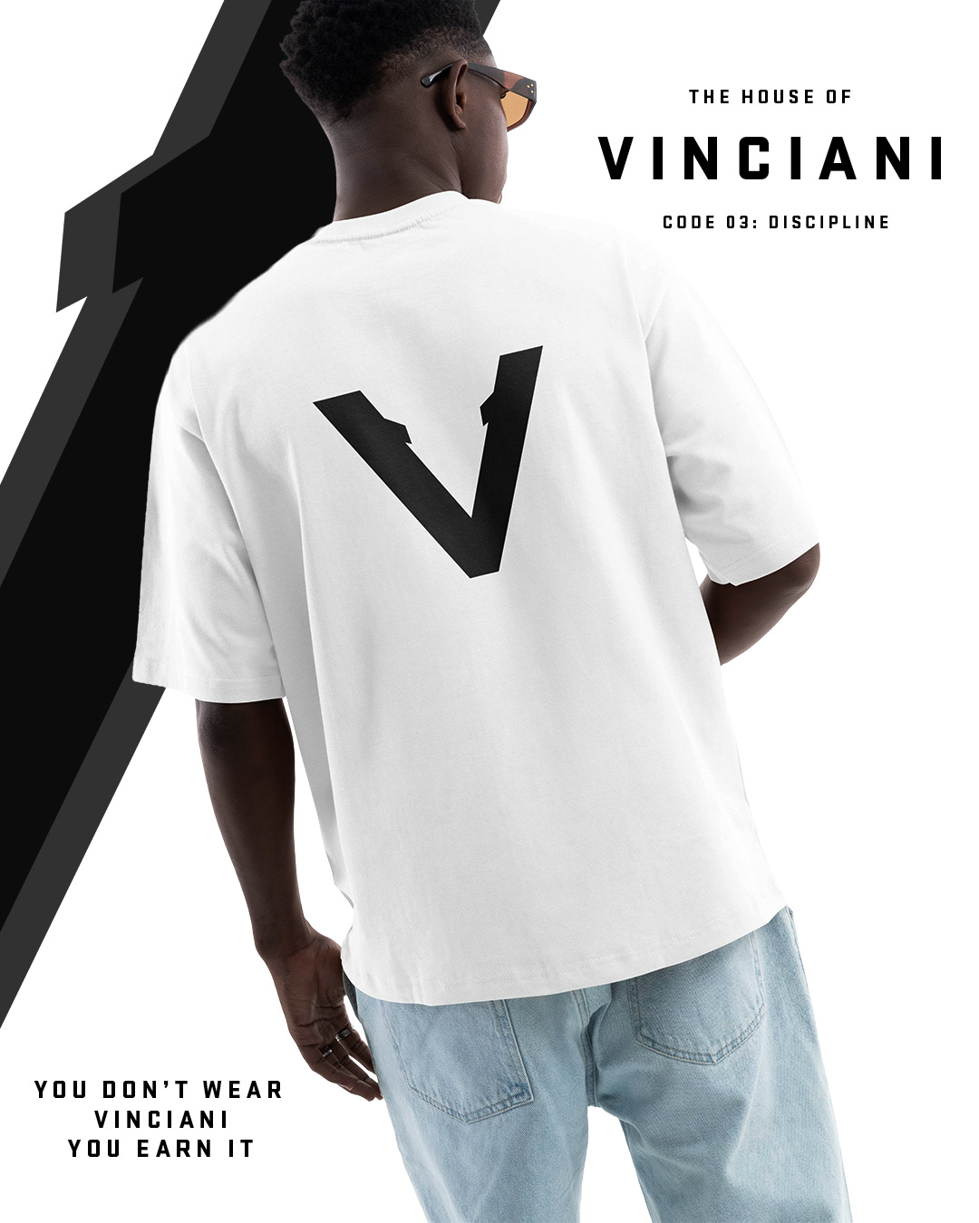 Male model wearing white Vinciani t-shirt with large black V-Mark on the back and minimal design.