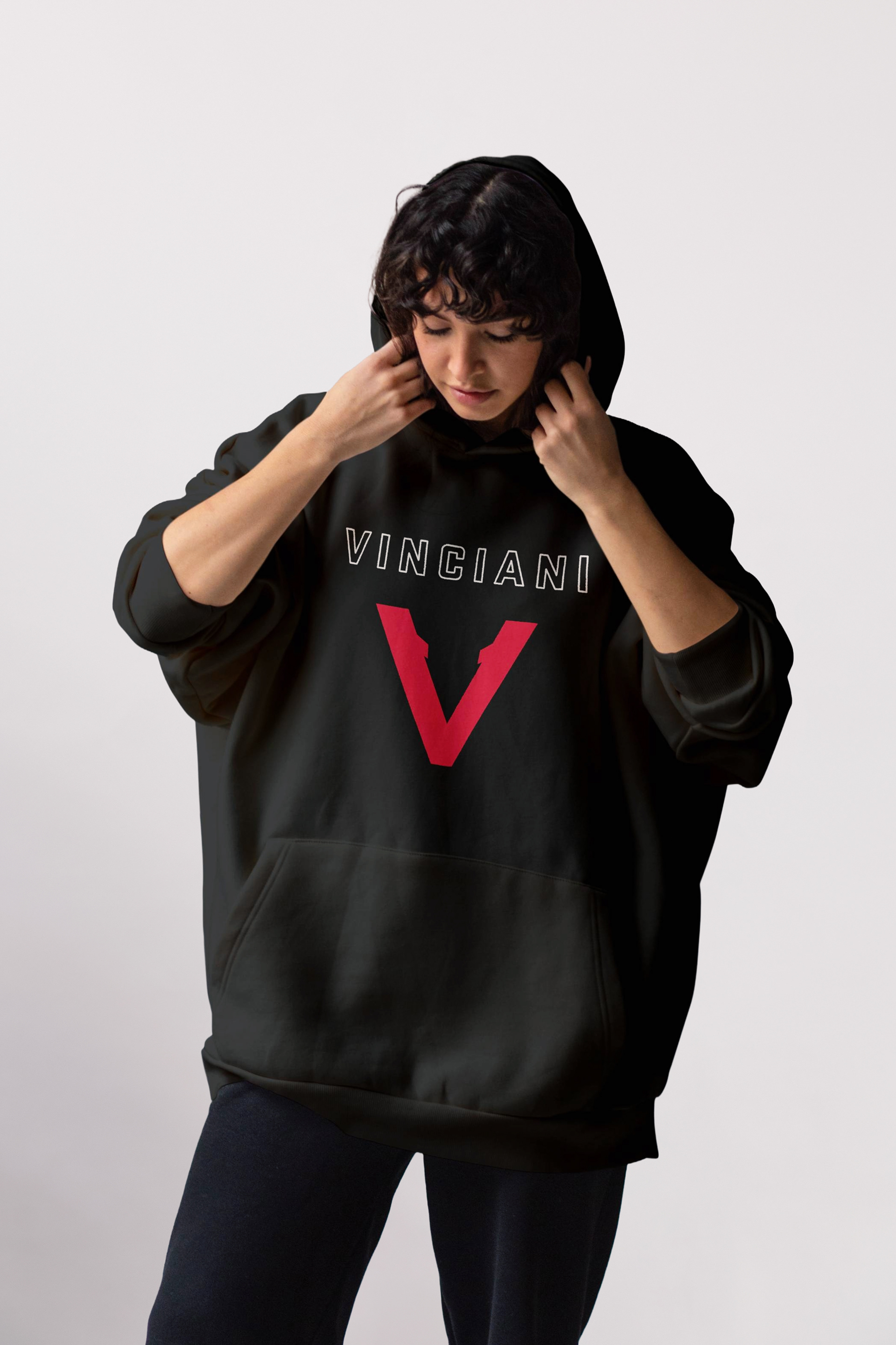 Female model wearing black Vinciani hoodie with red V-Mark logo representing strength, discipline and forward progression.