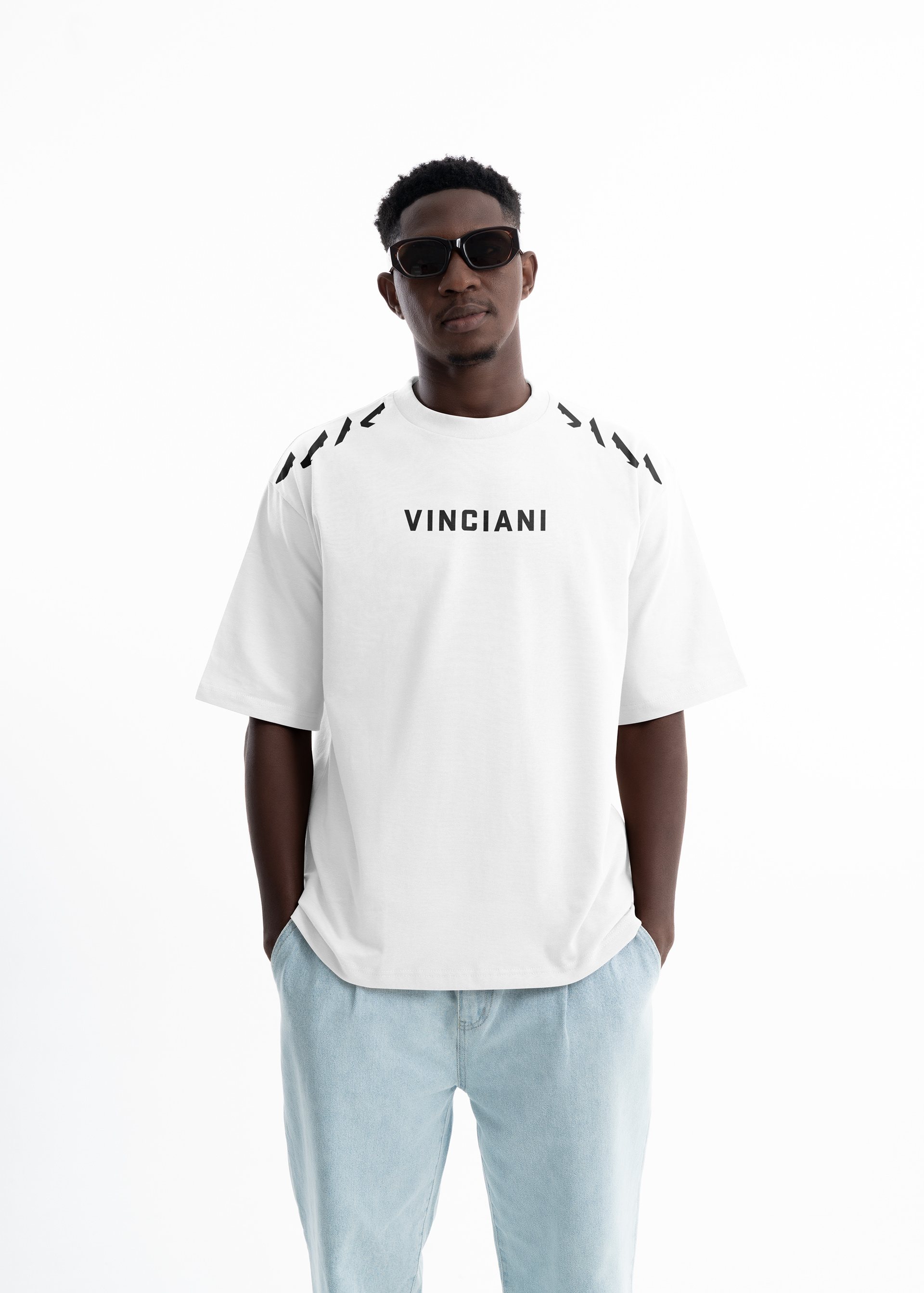 Vinciani Discipline Stripe oversized white T-shirt featuring the signature black shoulder stripe design, premium heavyweight cotton construction, and front wordmark worn by a male model.