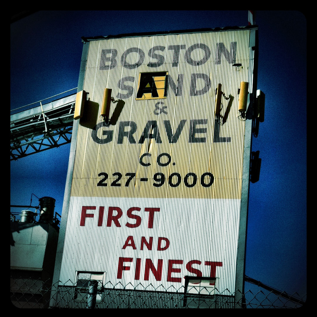 16. Boston Sand &amp; Gravel Sign ••• Boston Sand &amp; Gravel has been making concrete and other material for over 100 years, and was a big provider to Boston’s Central Artery/Tunnel project, aka the Big Dig. I’m not sure when this sign was installed but it’s been visible from Rt. 93 for as long as I can remember. The typeface is a geometric san-serif that was popular for sign makers in the mid-twentieth century. These letterforms eventually became the inspiration for the creation of the typeface “Gotham” by Tobias Frere-Jones in 2000. (#16 of 100 in the Boston Signage Project)