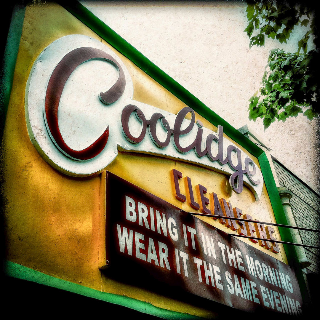 64. Coolidge Cleansers Sign ••• Coolidge Cleansers is one of those signs that was recently renovated, yet retains the look of the original worn out sign. The place has been renamed "Coolidge Looking Good" but for some reason they kept the old name in retro script on their facade.  (#64 of 100 in the Boston Signage Project)