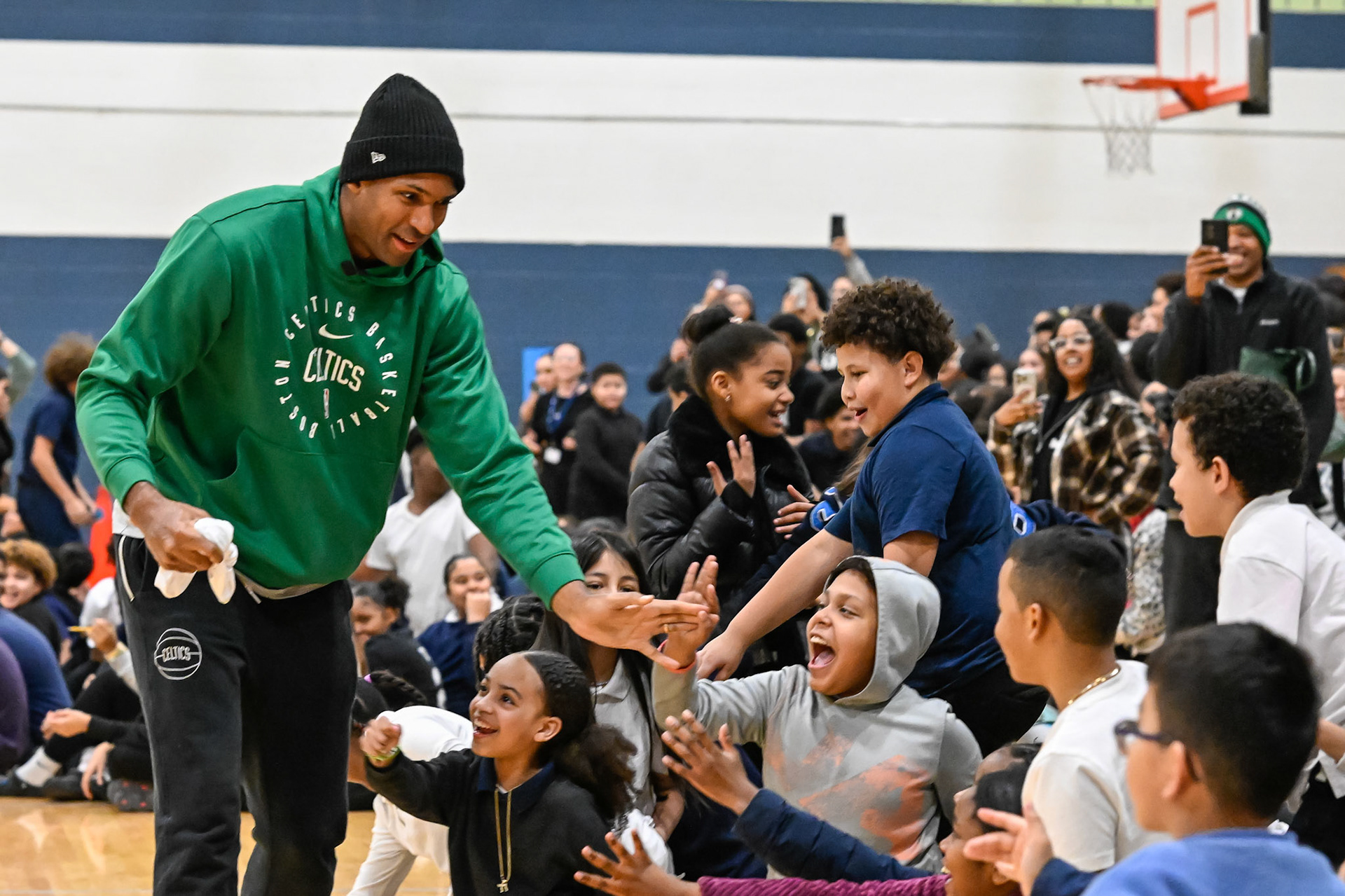 LAWRENCE, MA - DECEMBER 16, 2024: Boston Celtics player Al Horford, in-arena hostess Melissa Valdez, and chef Taysha Diaz visit with students for a community event at the Guilmette School in Lawrence, Massachusetts. (Photo by Keith Sliney).