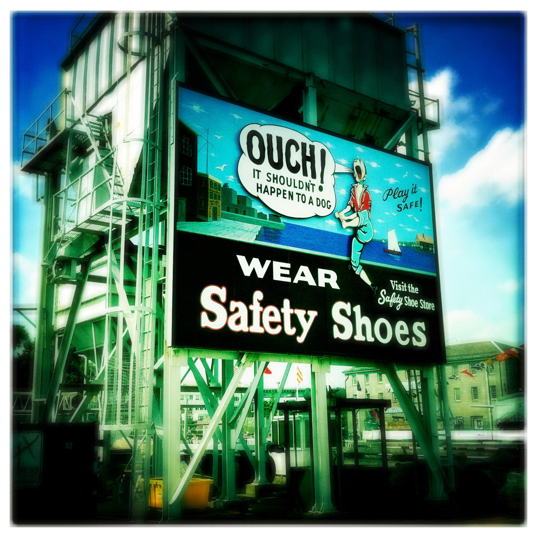 47. Wear Safety Shoes Sign ••• Facing the ocean side of the Charlestown Navy Yard is a WWII style reminder of wearing proper footwear. Although it’s been restored in the past year and has lost some of it’s faded worn-away look, it still is a classic and has a certain nostalgic charm. (#47 of 100 in the Boston Signage Project)
