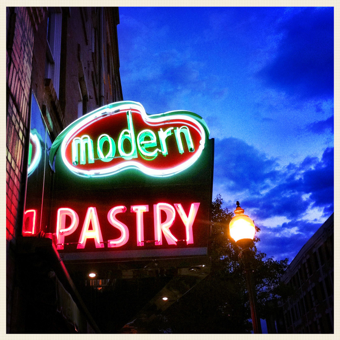 57. Modern Pastry Shop Sign ••• While Mike's attracts most of the tourists, Modern Pastry is a worthy North End rival across the street. The family-owned bakery has been around since the 1930s and many locals prefer Modern's lighter, crispier cannoli, which is piped to order on the spot. (#57 of 100 in the Boston Signage Project)