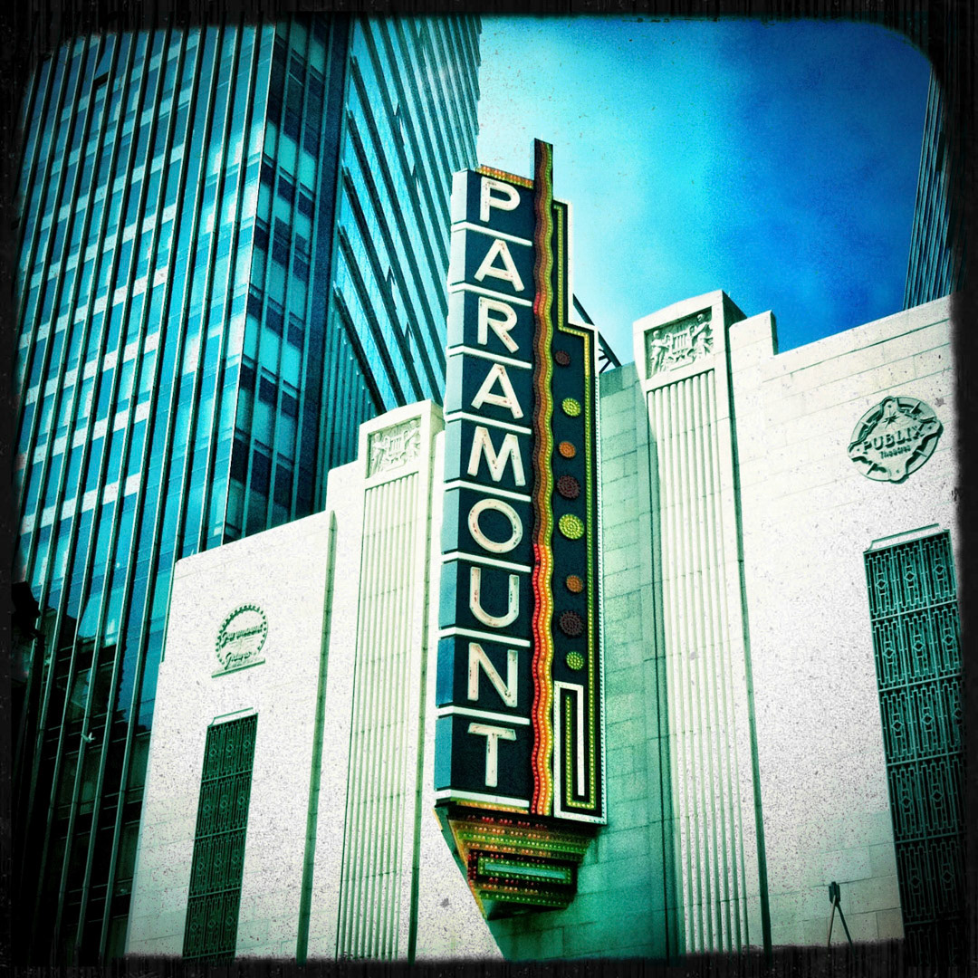 10. Paramount Theater Sign ••• When it opened its doors in 1932, the Paramount was one of the first movie houses in Boston to play talking motion pictures. As the area deteriorated, the once-thriving theater had been relegated to being a run-down porn house as part of the Combat Zone and closed down in 1976. The city and Emerson College lead a dramatic restoration of the Paramount to its former glory, with the marquee lighting up Washington Street with over 7,000 bulbs. (#10 of 100 in the Boston Signage Project)