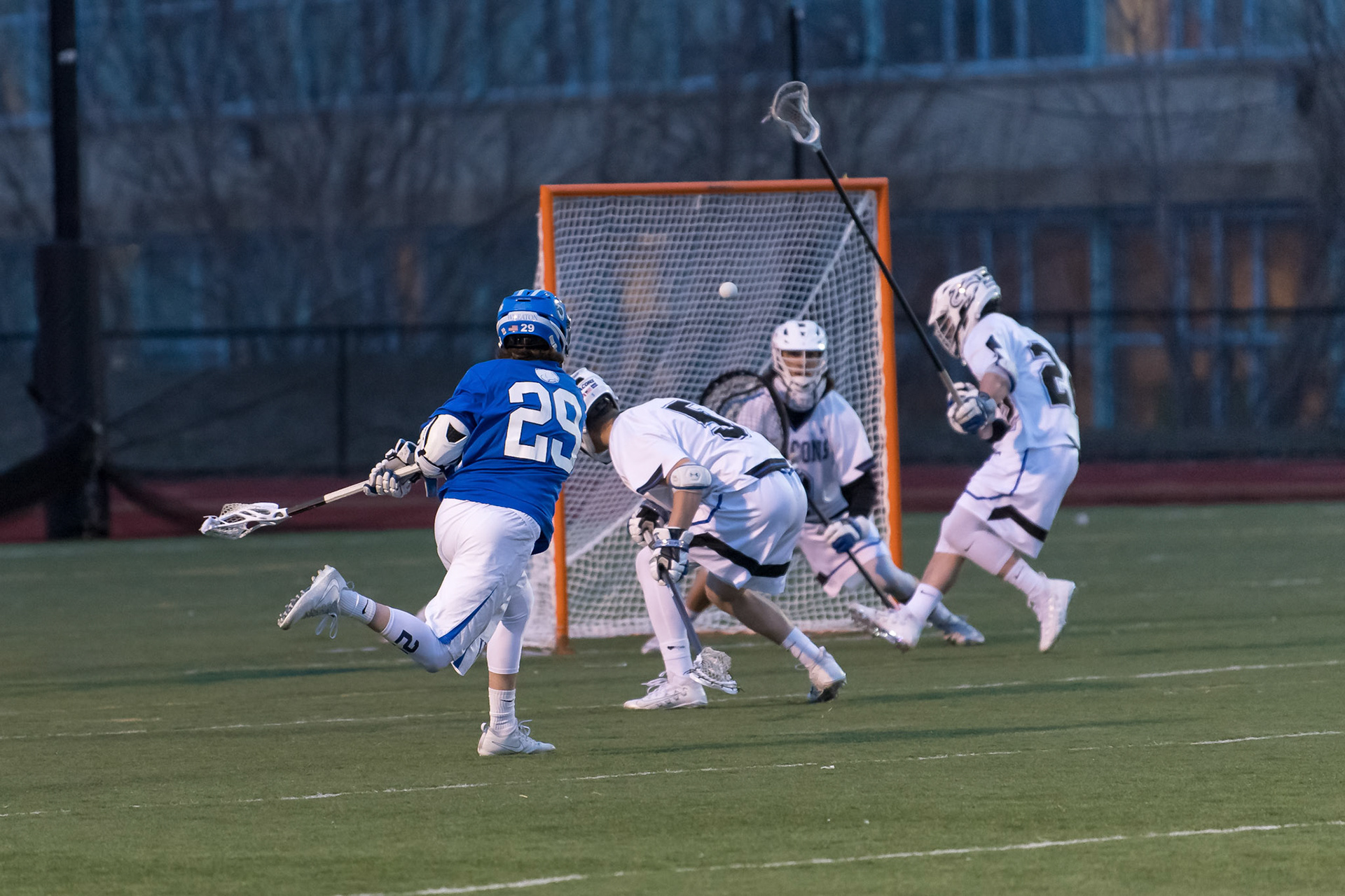 BOSTON, MA - MARCH 27, 2018: Wheaton College Lacrosse at UMass Boston. Lyons won 13-11. Photo by Keith Sliney.