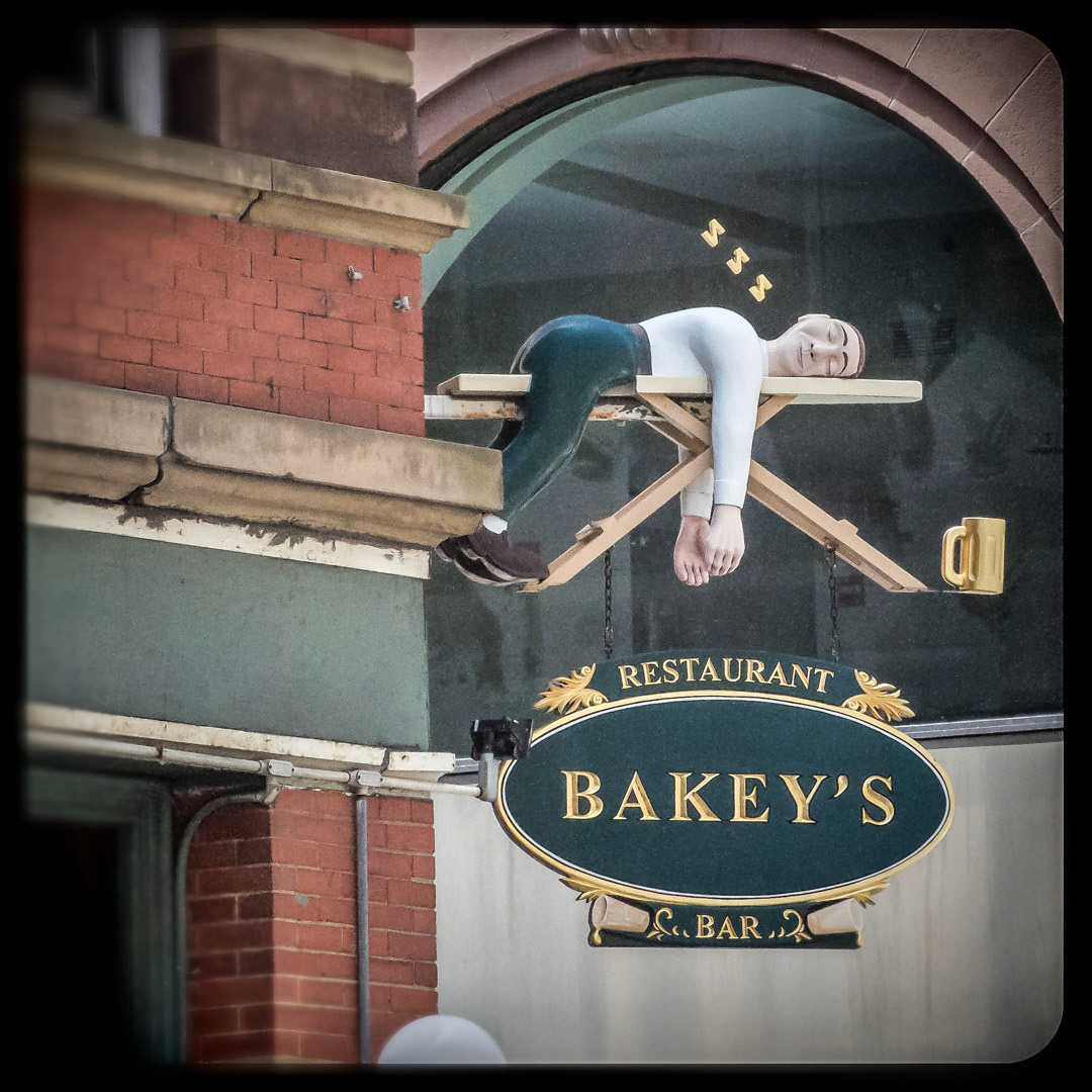 37. Bakeys Sign ••• Bakey’s, where all patrons eventually end up plastered and passed out on an ironing board. (#37 of 100 in the Boston Signage Project) ••• 2023 Update: Bakey's was shut down in 2011 and reopened under a different name. The sign was reportedly relocated to the offices of Broder, a real estate development company on Newbury Street.