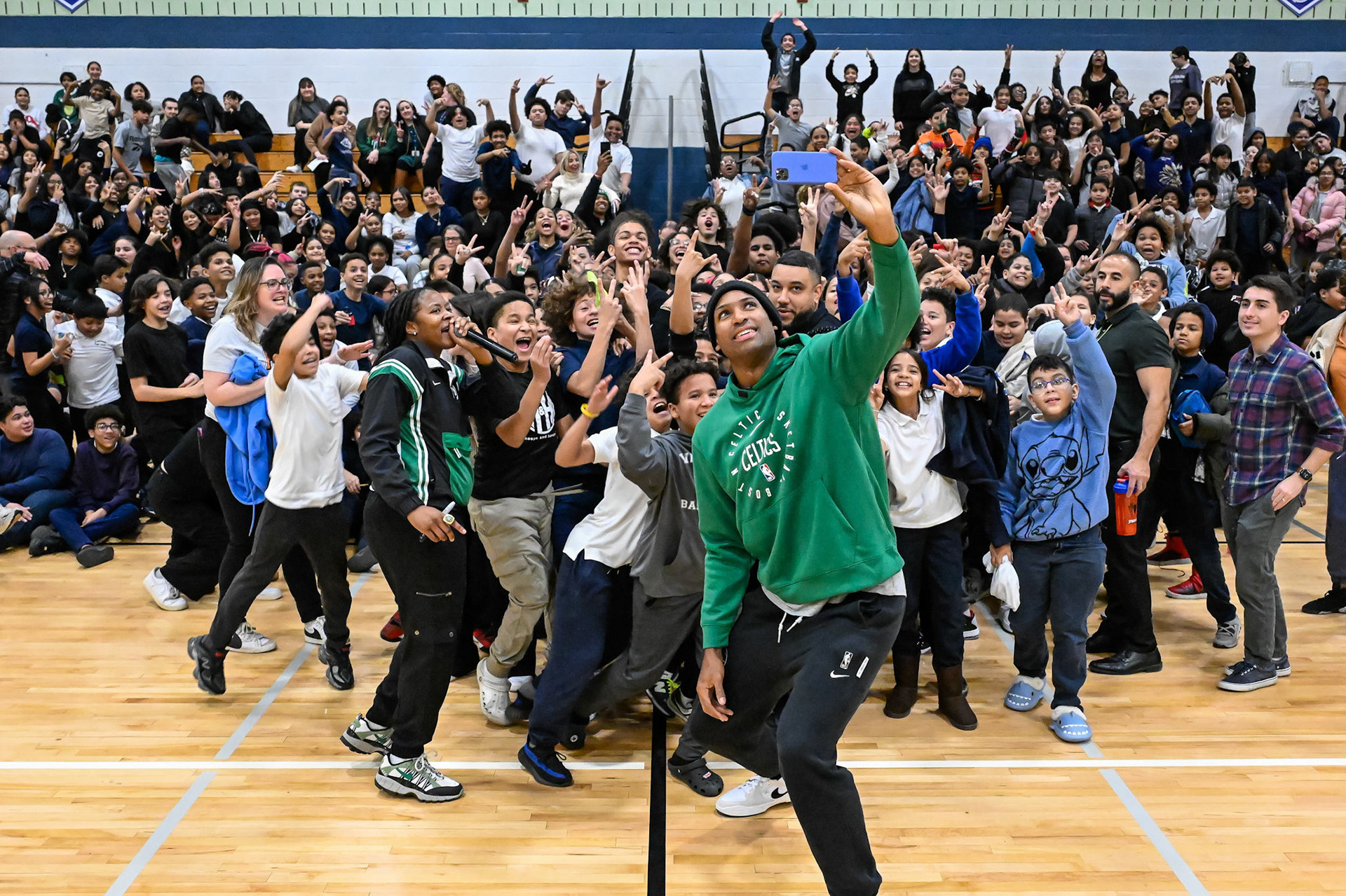 LAWRENCE, MA - DECEMBER 16, 2024: Boston Celtics player Al Horford, in-arena hostess Melissa Valdez, and chef Taysha Diaz visit with students for a community event at the Guilmette School in Lawrence, Massachusetts. (Photo by Keith Sliney).