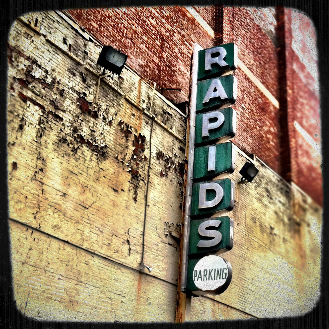 21. Rapids Parking Sign ••• On the corner of Merrimac and Friend Streets is one of the many parking lots that surround TD Garden, and this gem of a sign is tucked onto the 6-story Forecaster Building there. (#21 of 100 in the Boston Signage Project) ••• 2023 Update: Sign was removed and status is unknown.