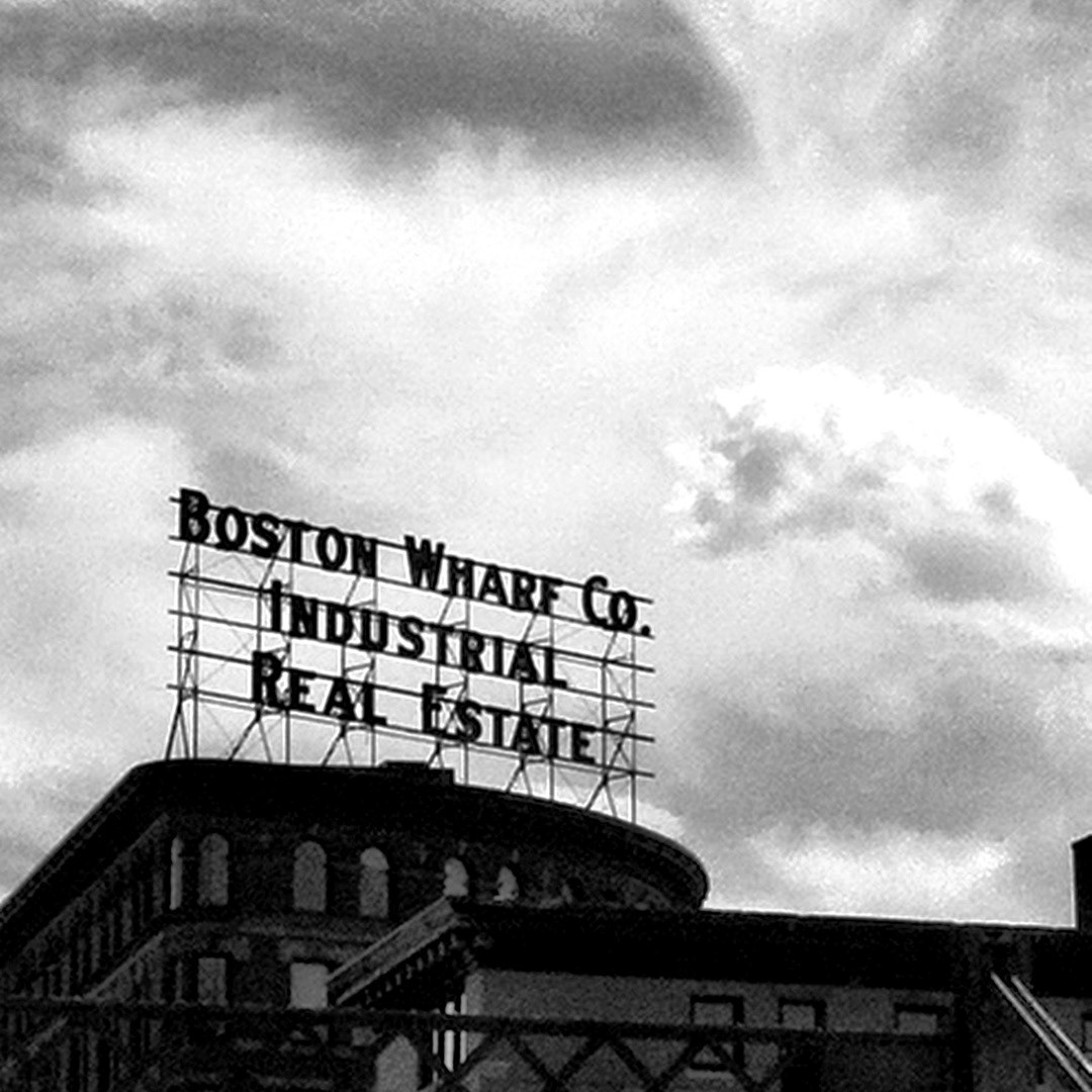 20. Boston Wharf Co Industrial Real Estate Sign ••• Atop 263 Summer Street lies this landmark 59-foot-wide beauty. The Boston Wharf Company has been gone for decades now, but the vintage sign stayed, unlit until 2006 when developers refurbished it for $200,000. Now it’s been restored to the same ruby-red glow it had when it was constructed in 1910. (#20 of 100 in the Boston Signage Project)