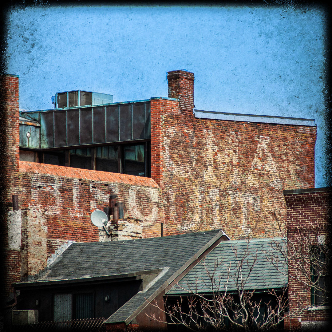 68. Biscuit Ghost Sign ••• On North Washington Street in Boston's Italian district is this old ghost sign advertising biscuits. A chunk of the type was removed long ago so it's difficult to conclude which company painted the ad. The only type visible above "BISCUIT" is 3 letters: "OMA". Many years ago there was a company located about a block away called the Loose-Wiles Biscuit Company. They eventually formed the brand Sunshine Biscuits, which is still around today. They created many brands of baked goods such as Cheez-its, Animal Crackers and Hydrox cookies, but my guess is that this sign once displayed another one of their products - TAKHOMA BISCUIT. (#68 of 100 in the Boston Signage Project)