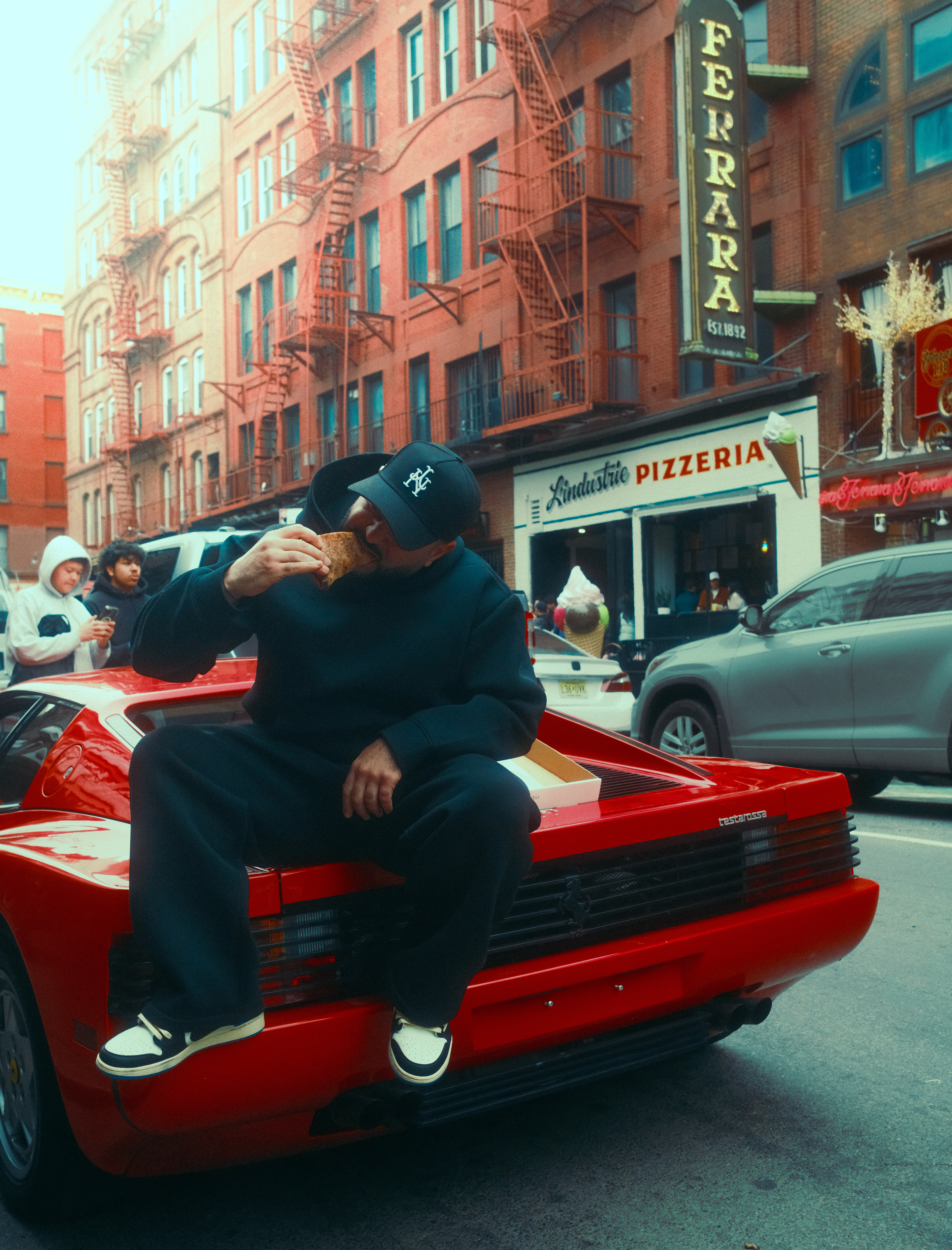 Rosco eating a slice on a Ferrari