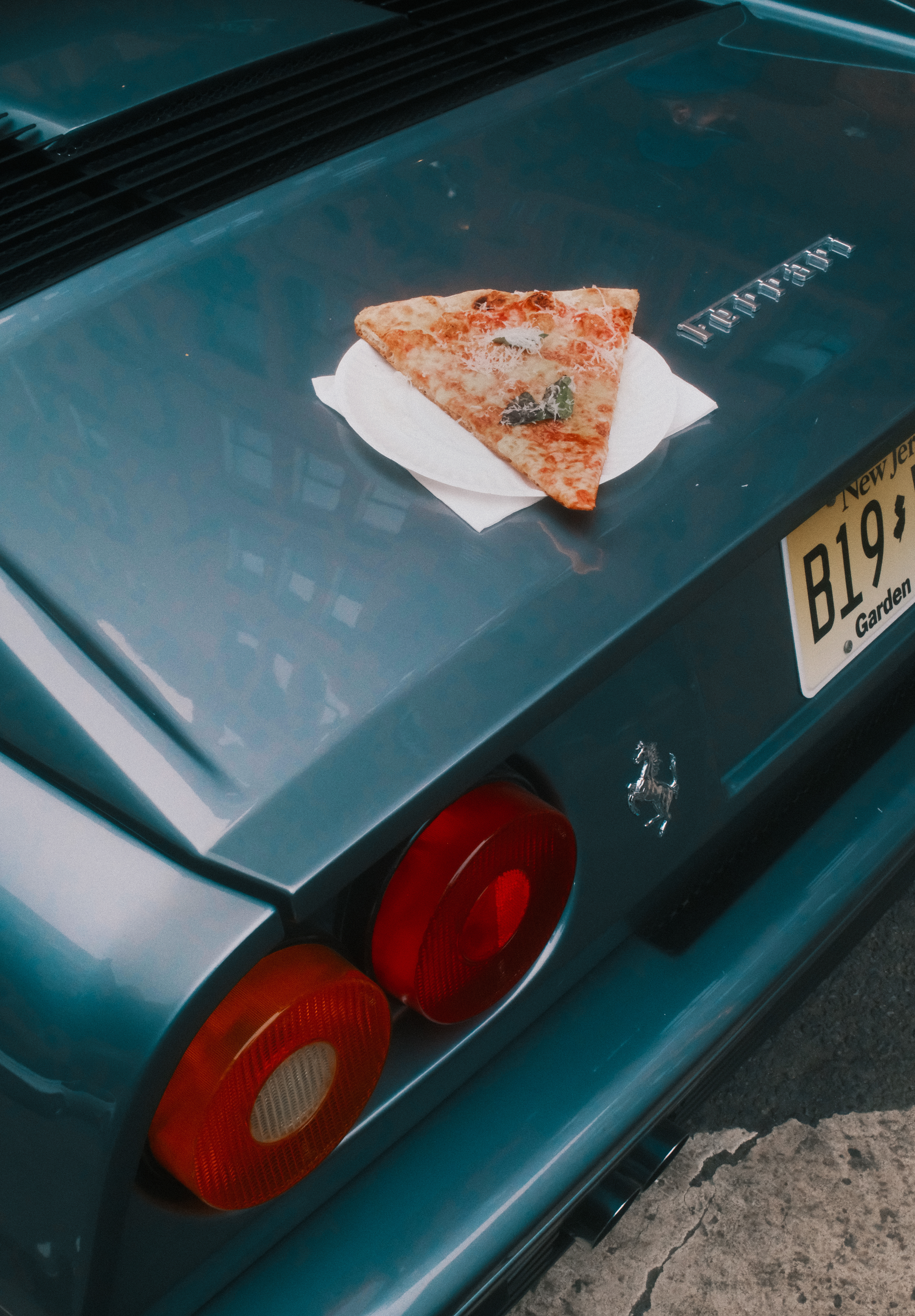 A slice of pizza on a Ferrari