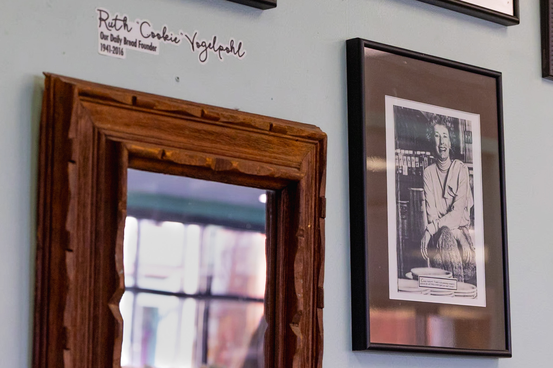 17- Taking up all of the space on the wall at the exit of Our Daily Bread is an assortment of significant frames, some of which are in honor and remembrance of the founder, Ruth “Cookie” Vogelpohl. Cookie passed away at the age of 75, and Our Daily Bread honors her work with a wall of their accomplishments as you walk into the building. Cookie was working in a part of Cincinnati called Over-the-Rhine when she noticed a man searching through the trash for a meal. Cookie then decided to make a change when she started a meal program at St. Francis’s school kitchen that was hosted two times a week. After her numbers of attendees grew from 9 to 200, Cookie realized that food was a great start but not enough. She then made the effort to create the safe place that Our Daily Bread prides themselves on today. She started the project with less than $1000 and opened the doors to Our Daily Bread less than a year later with 10 people showing up to be served on opening day. The tradition has continued until today with the numbers rising every year.