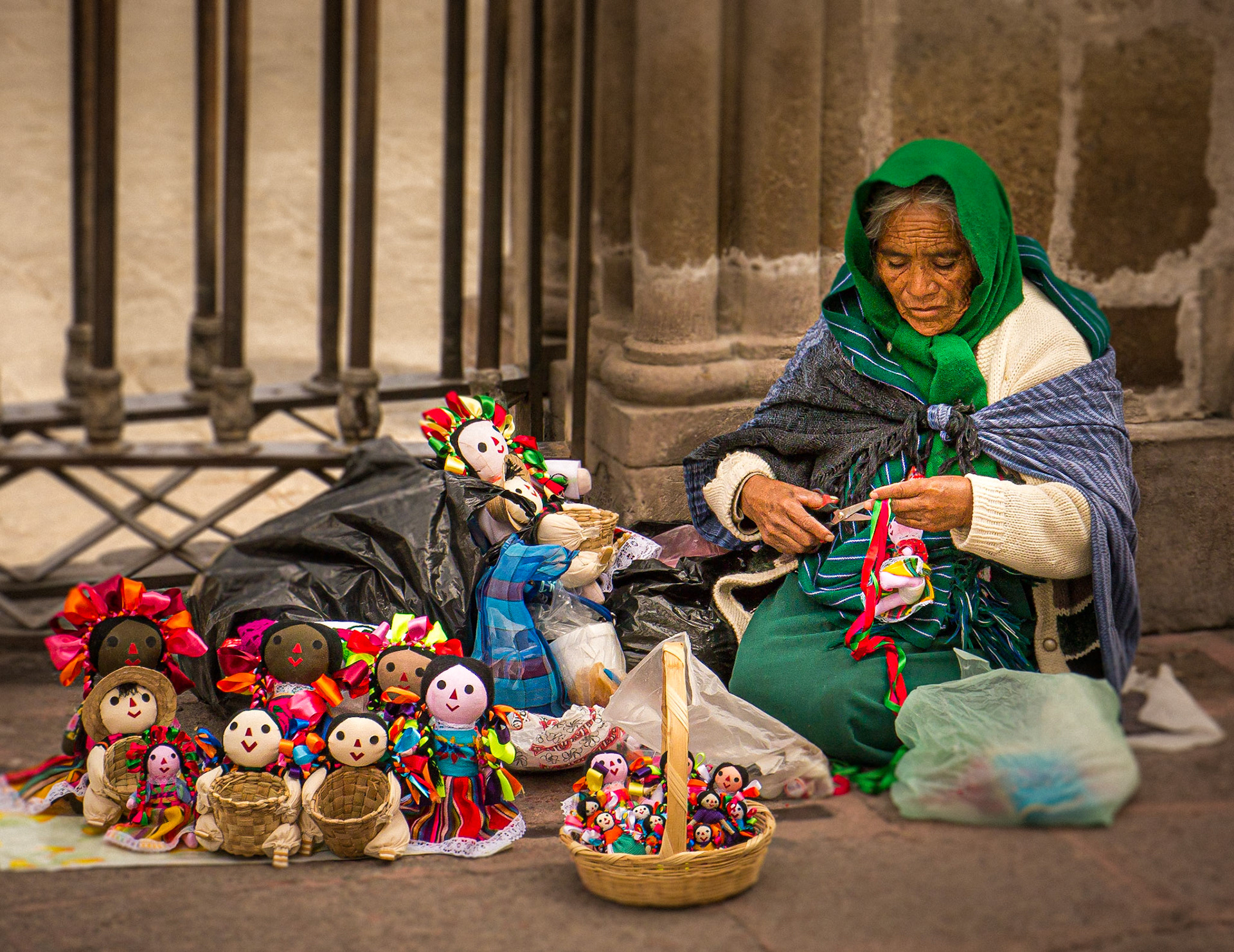 October 10, 2019Street vender making dolls for sale in San Miguel de Allende, Mexico.