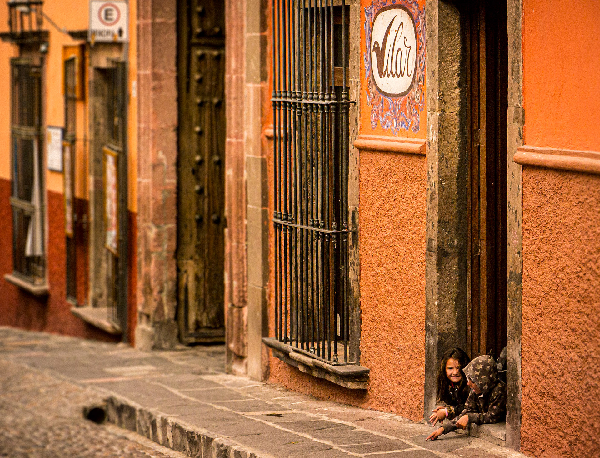 March 3, 2020Two kids playing in doorway in San Miguel de Allende, Mexico.