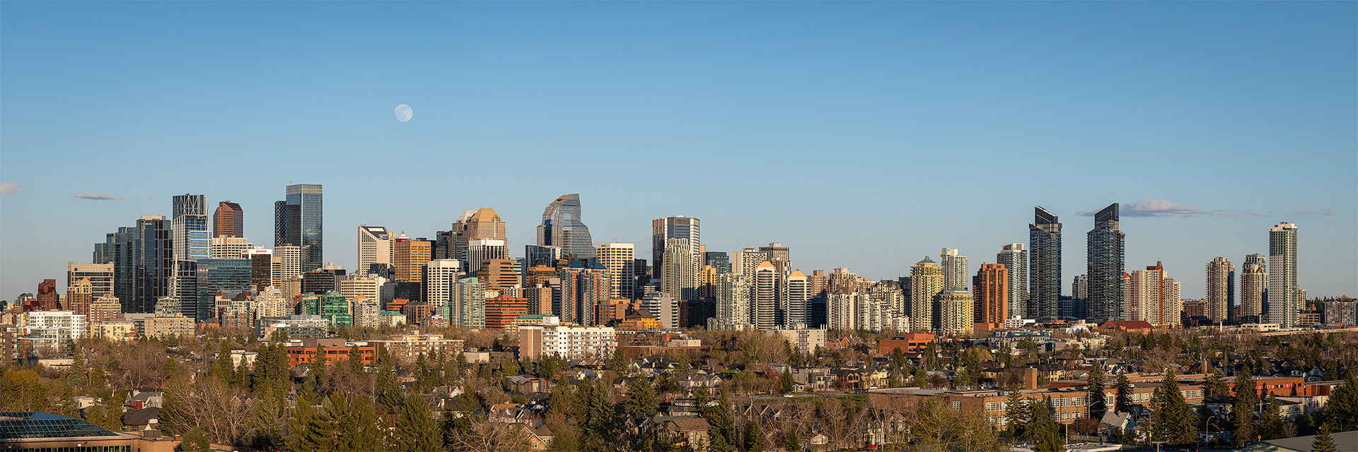 3x1 Panoramic Cityscape (8 shot) of the downtown skyline and Moonrise (Waxing Gibbous phase @ 98.4%, elevation 5.6 degrees), from Grasshopper Hill, West Hillhurst, Calgary, AB