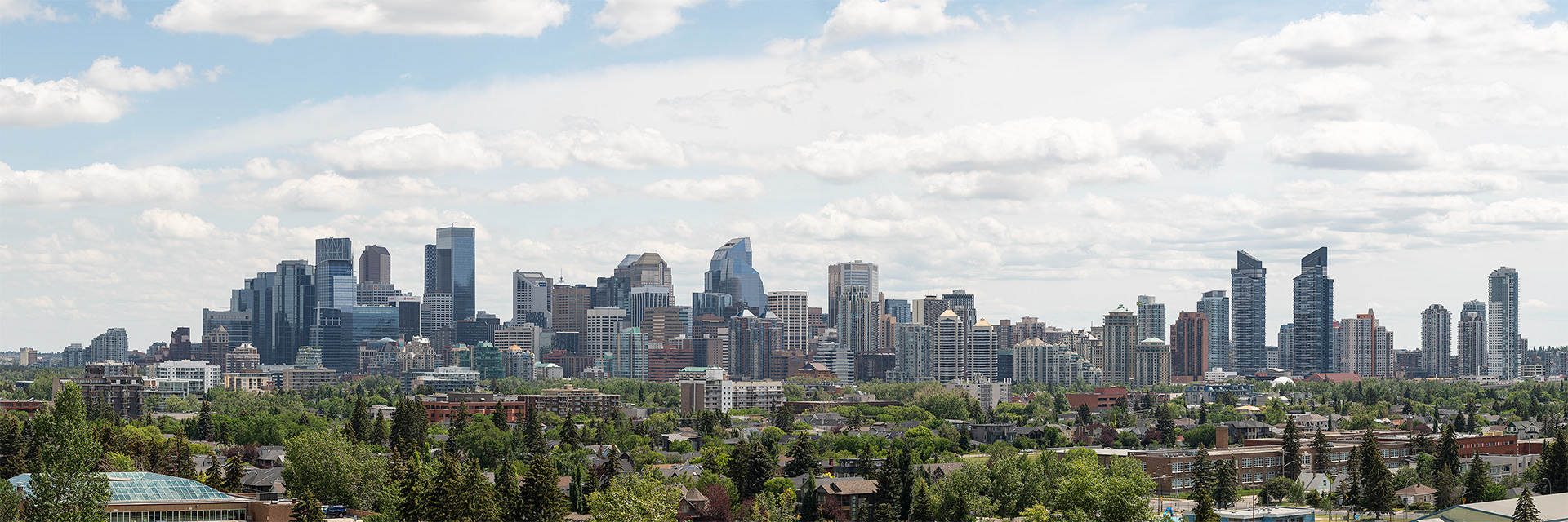 3x1 Panoramic Cityscape of the Downtown Calgary skyline at Mid Afternoon, from West Hillhurst off-leash area (Grasshopper Hill), Calgary, AB