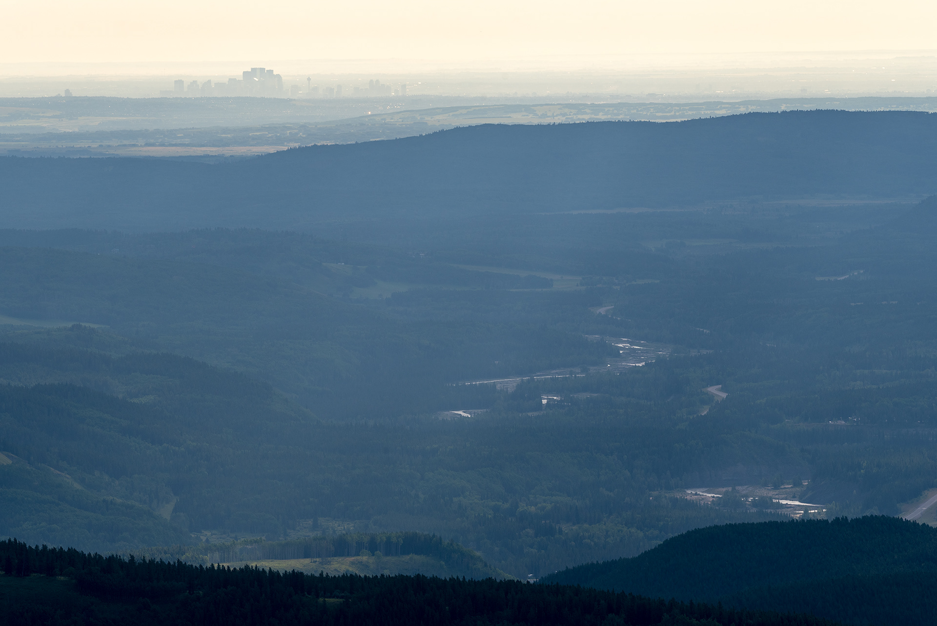 A view from part way up Prairie Mountain, with downtown Calgary in the hazy distance