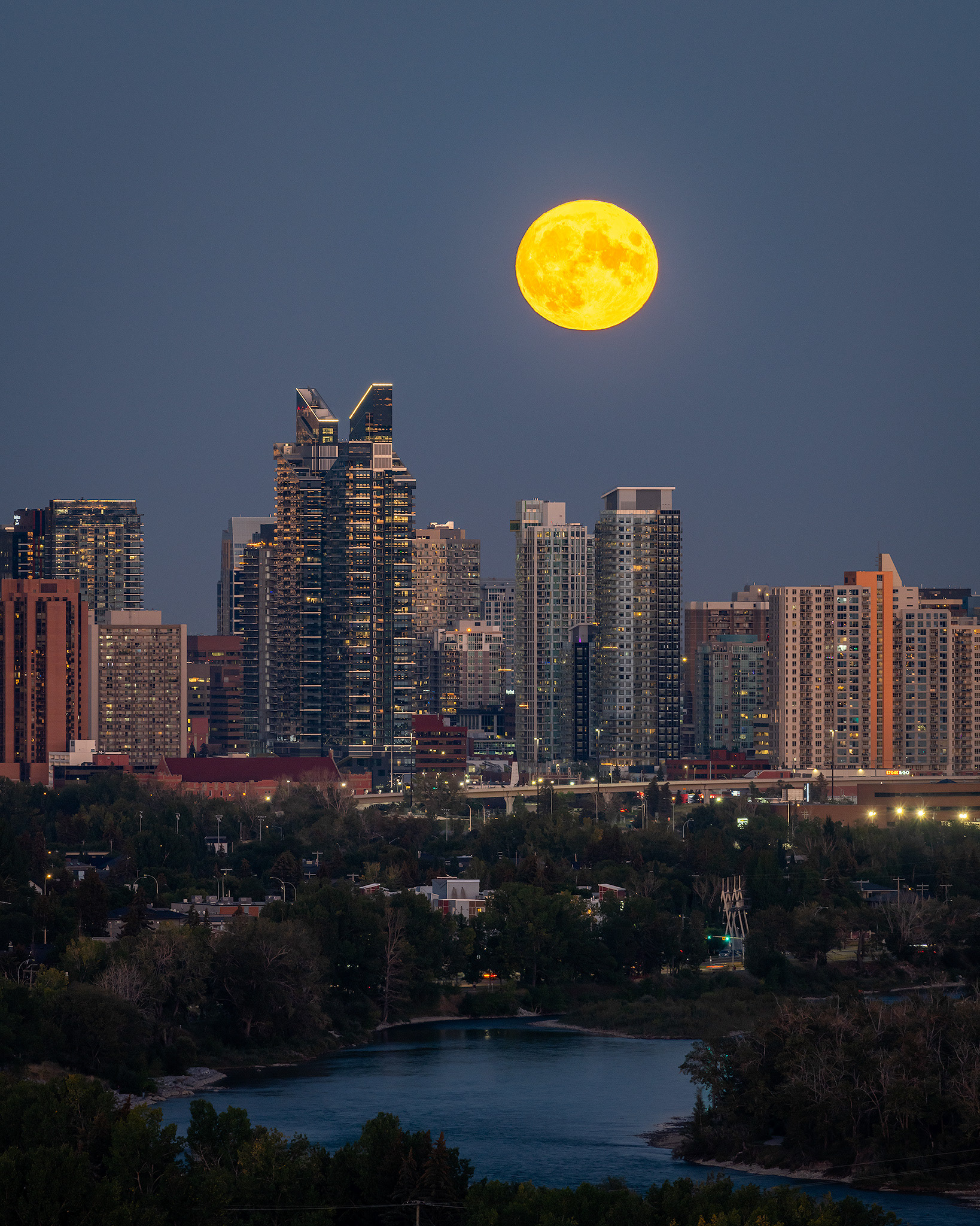 4x5 Cityscape of the Bow River, and the Downtown West End Calgary skyline with the Harvest Moon aligned nicely above, from Edworthy Park, Calgary, AB