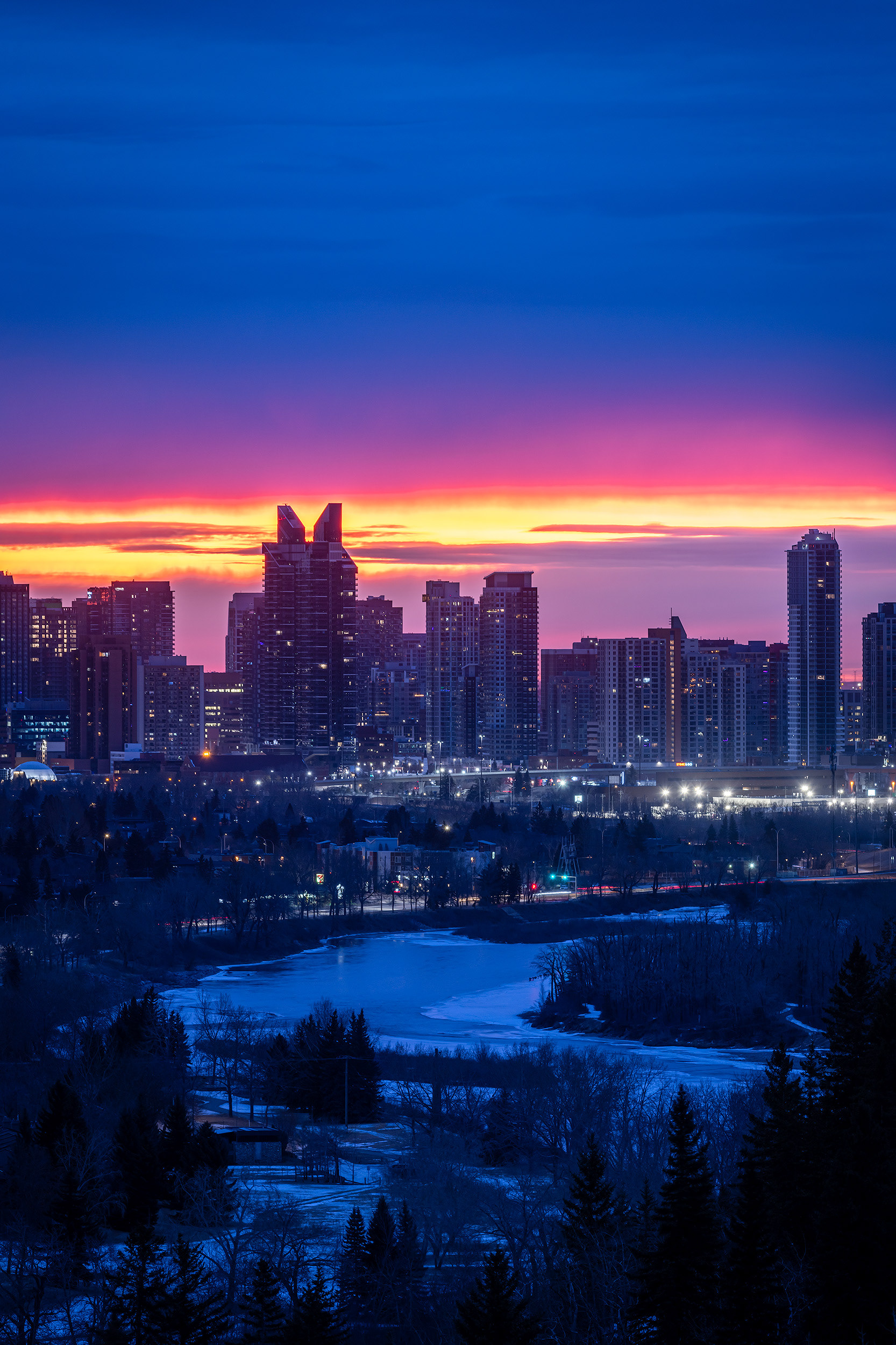 Cityscape, partial of the downtown skyline [pre sunrise, Civil Twilight (sun altitude -4.8 degrees)] from Edworthy Park, Calgary, AB