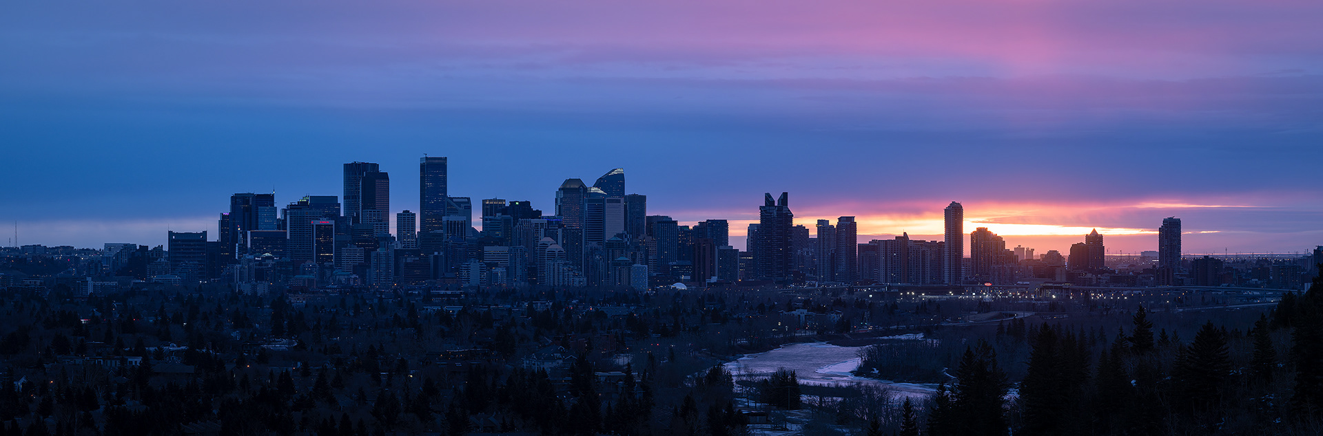 3x1 Panoramic Cityscape (8 shot) of the downtown skyline [pre sunrise, Civil Twilight (sun altitude -1.2 degrees)] from Edworthy Park, Calgary, AB