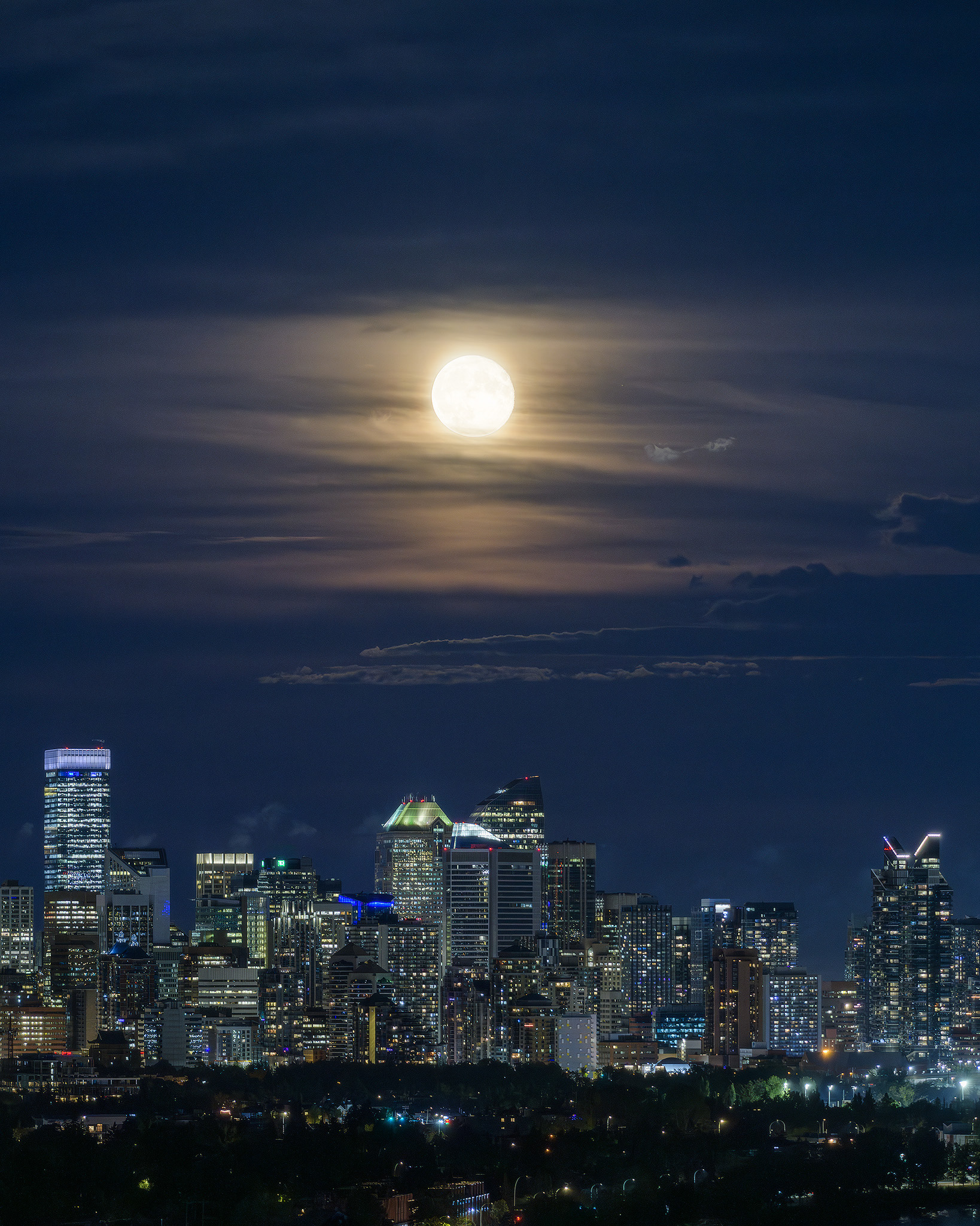 Photo of the Downtown Calgary skyline with rising Sturgeon Moon (one night past at 97.1%), from Edworthy Park, Calgary, AB - August 20th