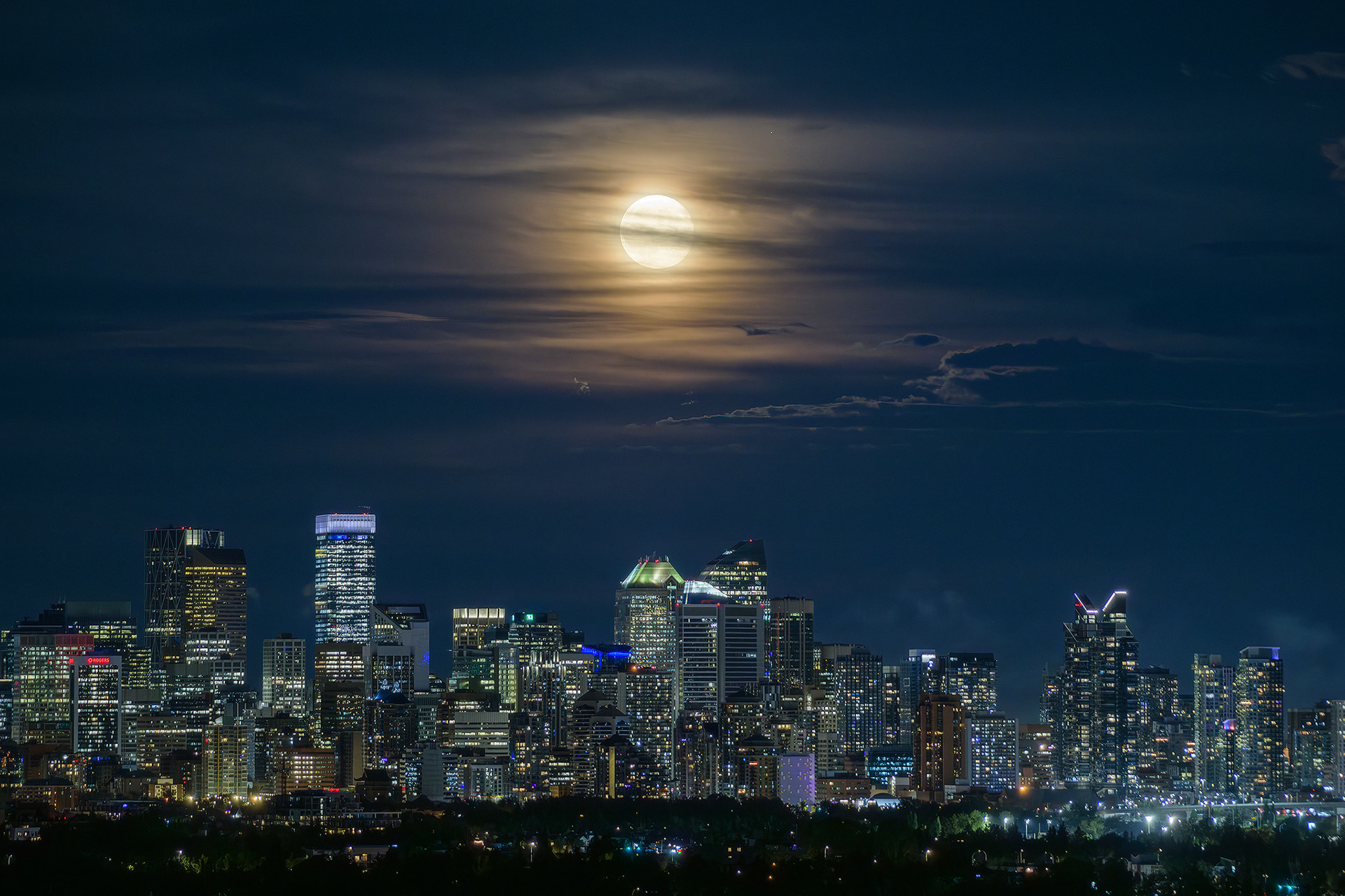 Photo of the Downtown Calgary skyline with rising Sturgeon Moon (one night past at 97.1%), from Edworthy Park, Calgary, AB - August 20th