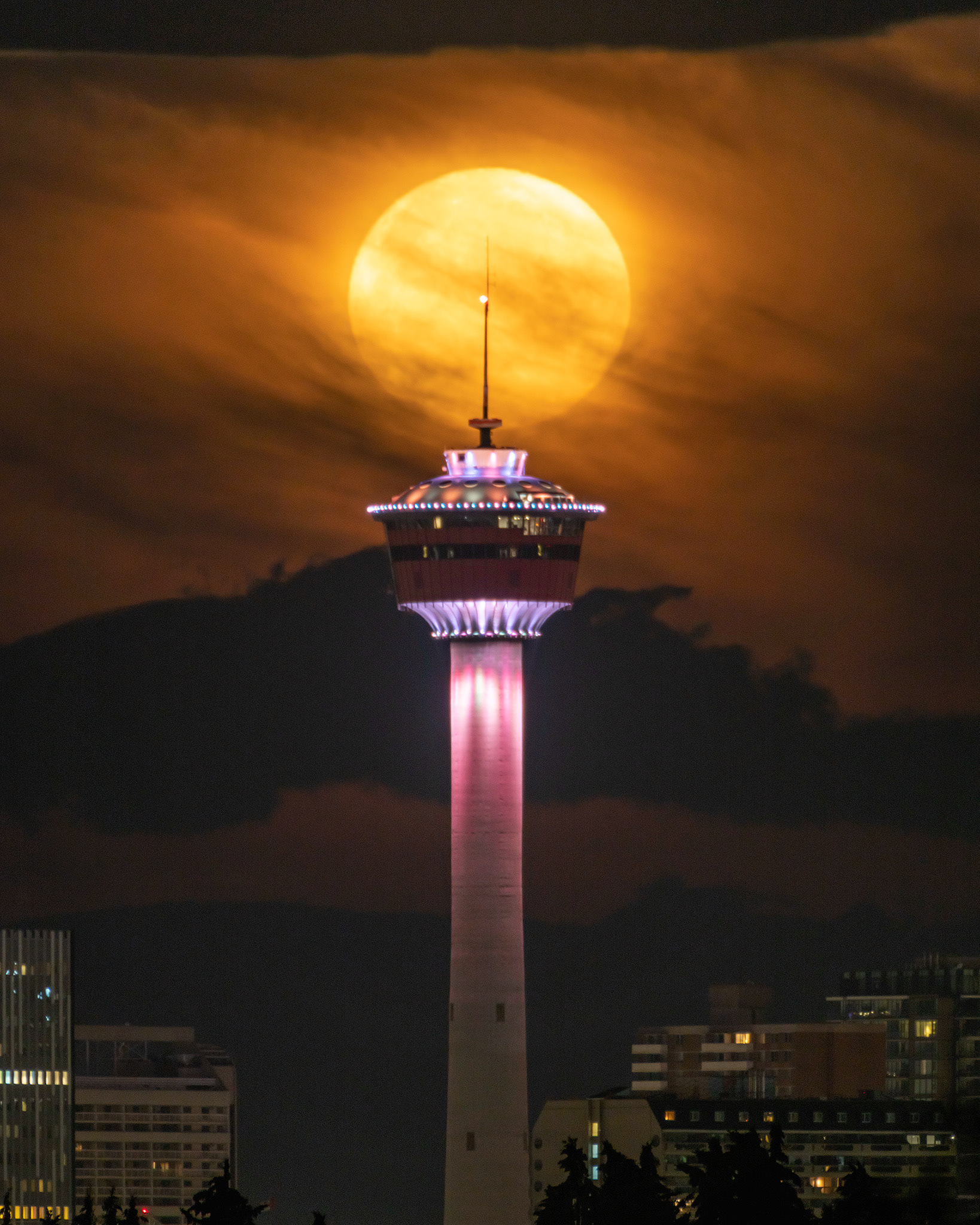 Full Sturgeon Moonset aligned with the Calgary Tower, from Vista Heights Vista, NE Calgary, AB