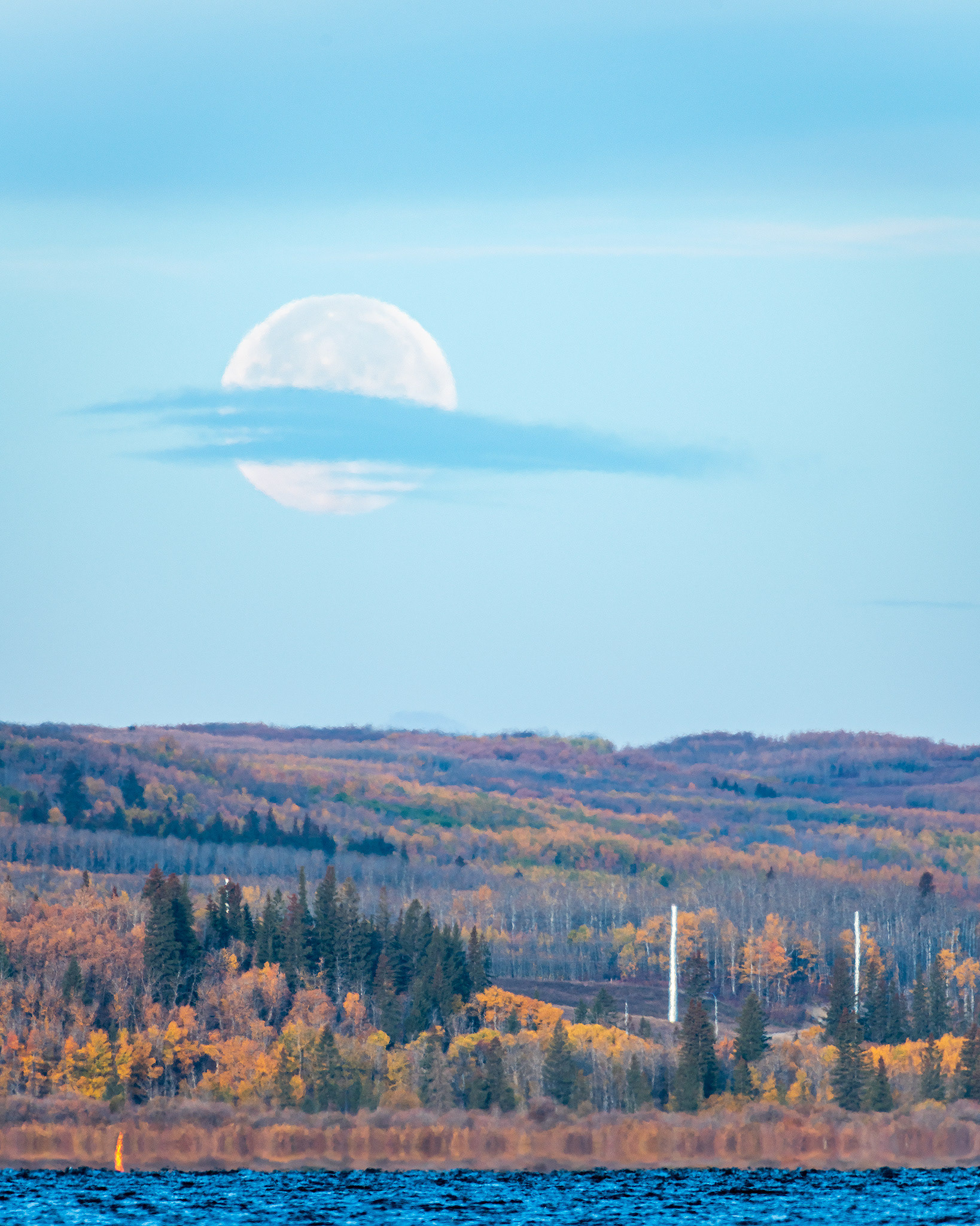 The Moon on its way to setting behind Weaselhead Flats, from the Glenmore Reservoir's water's edge, near The Big "H" of Heritage Park, Calgary, AB - October 10th (8:29 AM, 38 Mp)