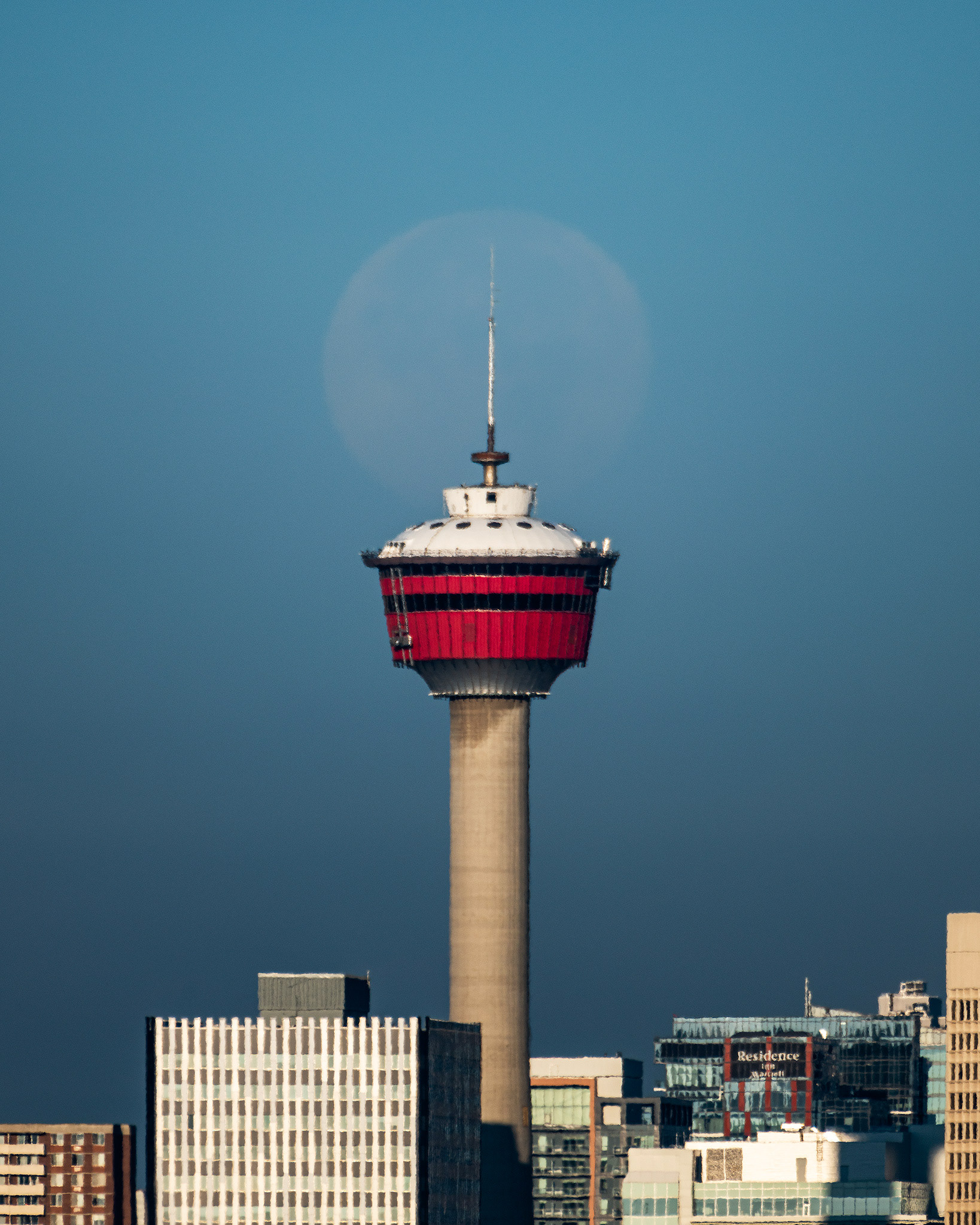 Setting Moon (98.1%) aligned with the Calgary Tower, from Barlow Trail SE, Calgary, AB
