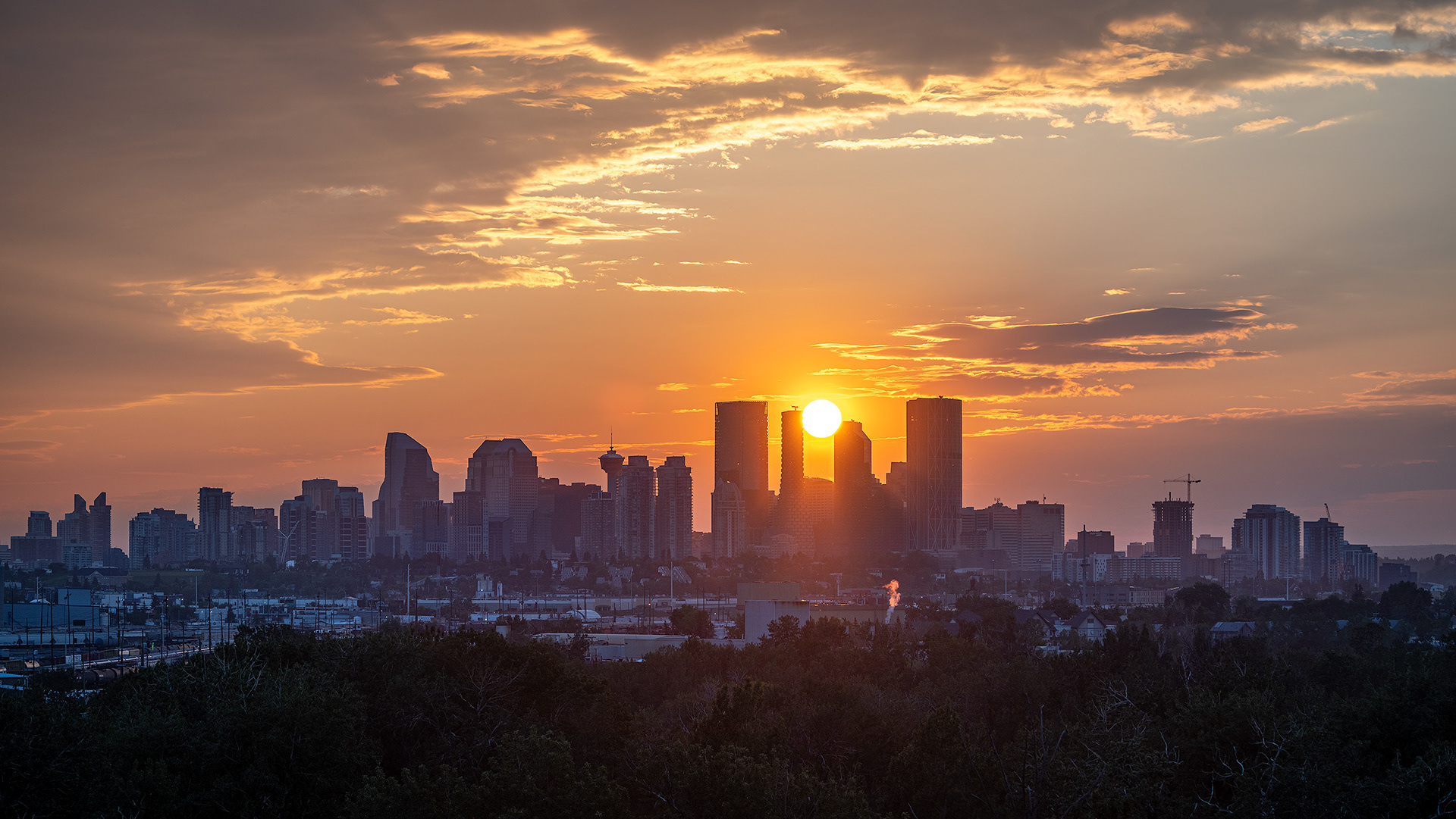 16x9 Cityscape of the downtown skyline at Sunset, from Southview Off Leash Dog Park, Calgary, AB