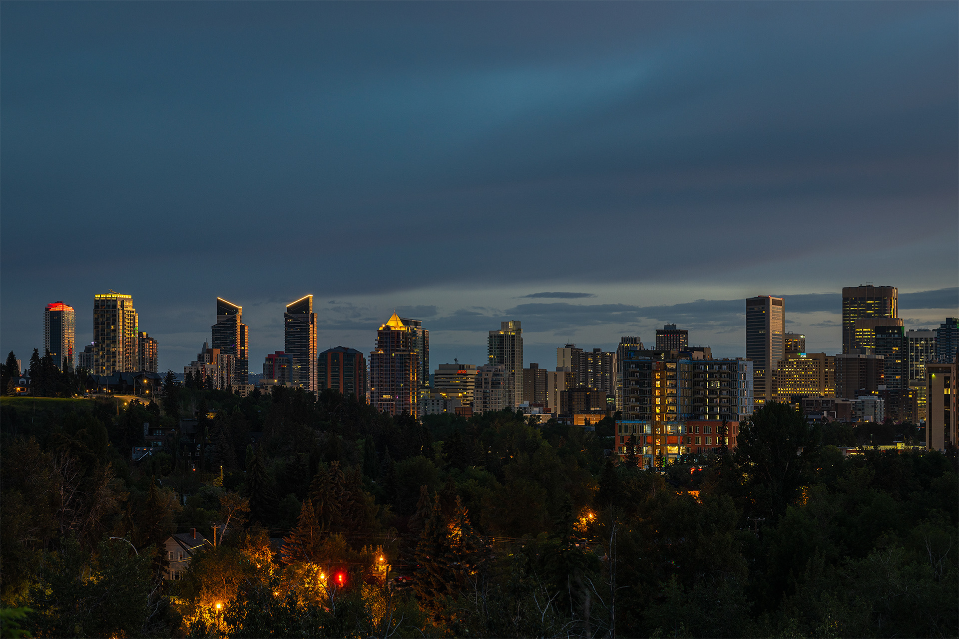 Cityscape of the Downtown Calgary West End skyline at Sunrise, from near Roxboro Park, Calgary, AB