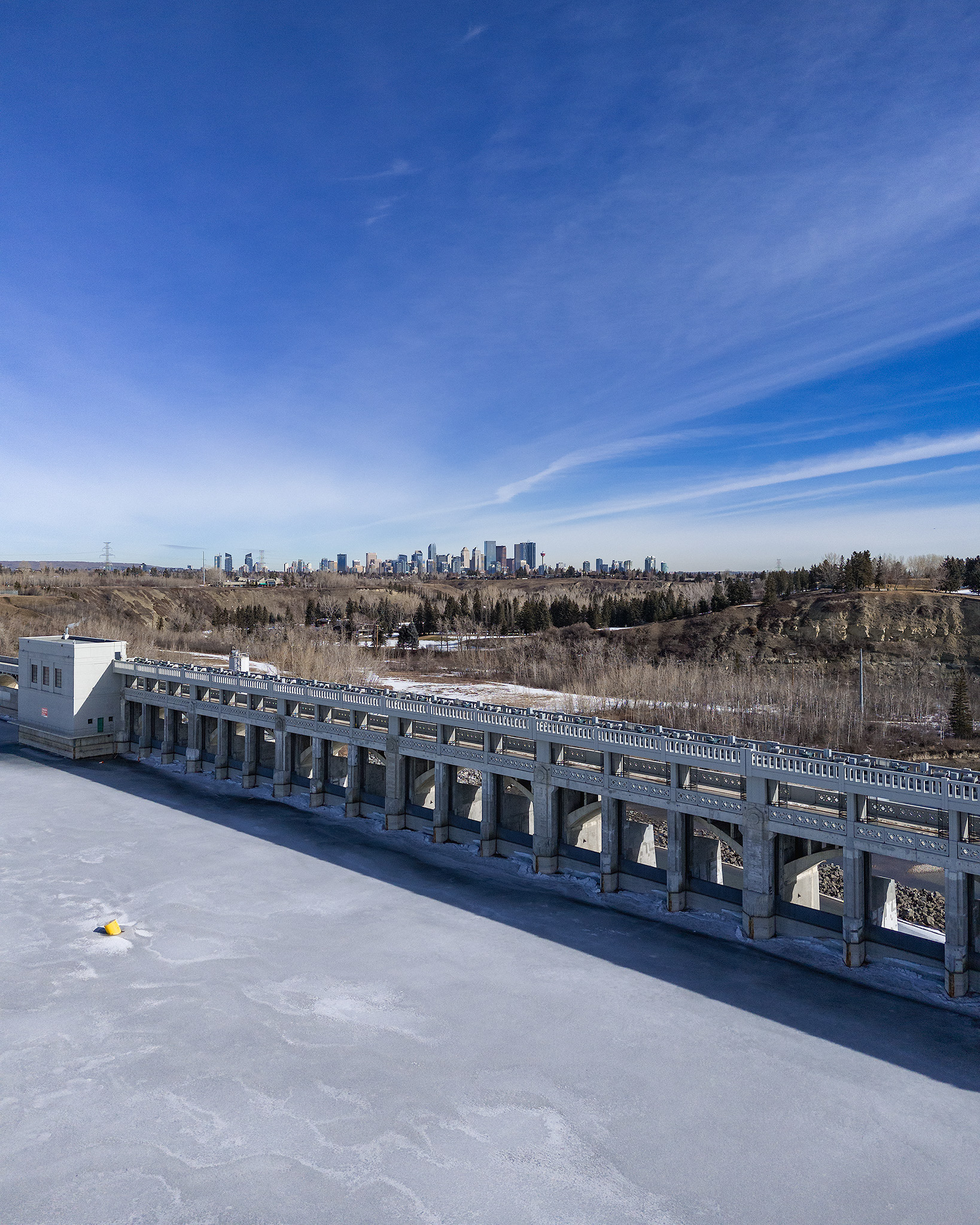 A photo of the Glenmore Dam, with the Downtown Calgary skyline in the background, Glenmore, Calgary, AB - March 14th