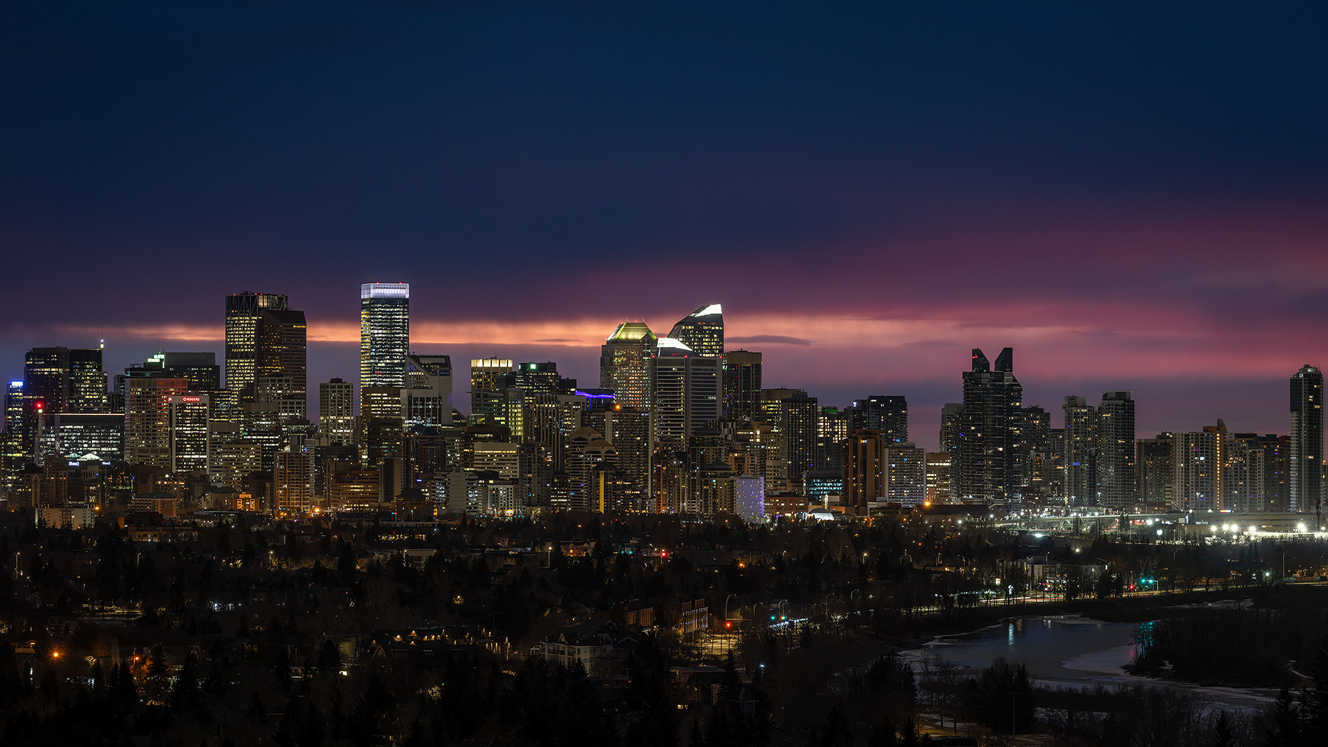 16x9 Panoramic Cityscape (5 shot) of a portion of the downtown skyline [pre sunrise, Nautical Twilight (sun altitude -7.2 degrees)] from Edworthy Park, Calgary, AB