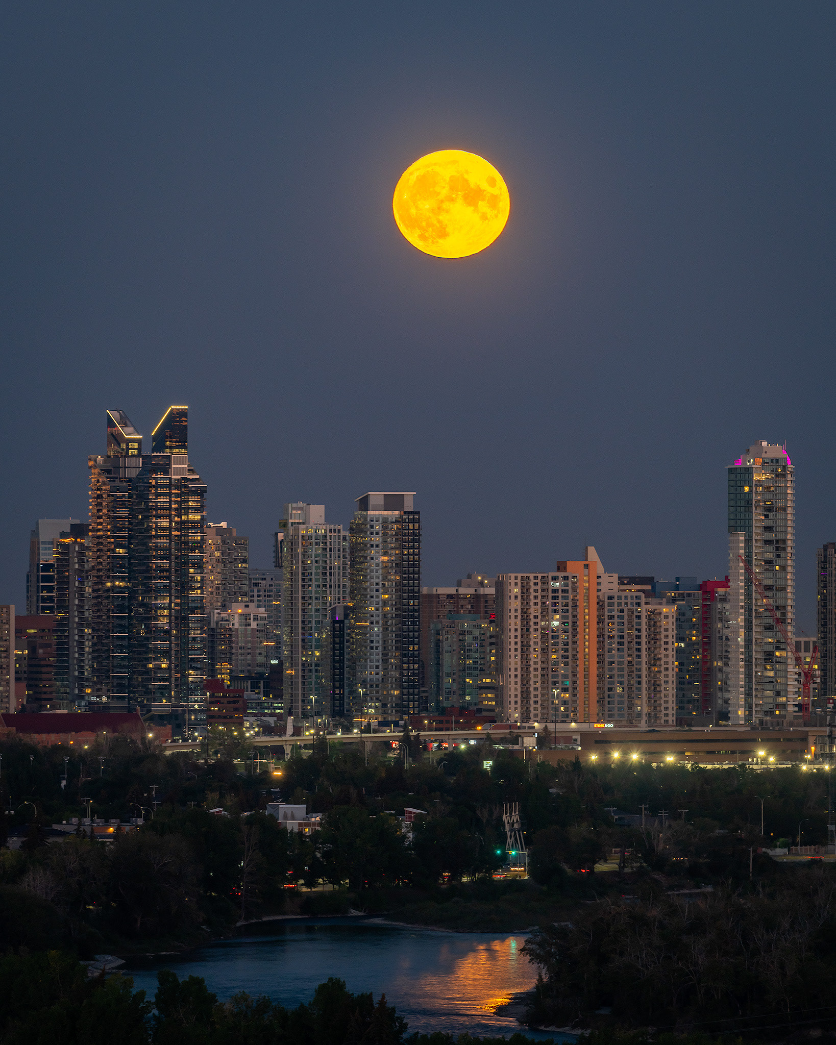 4x5 Cityscape of the Bow River, and the Downtown West End Calgary skyline with the Harvest Moon aligned nicely above, from Edworthy Park, Calgary, AB