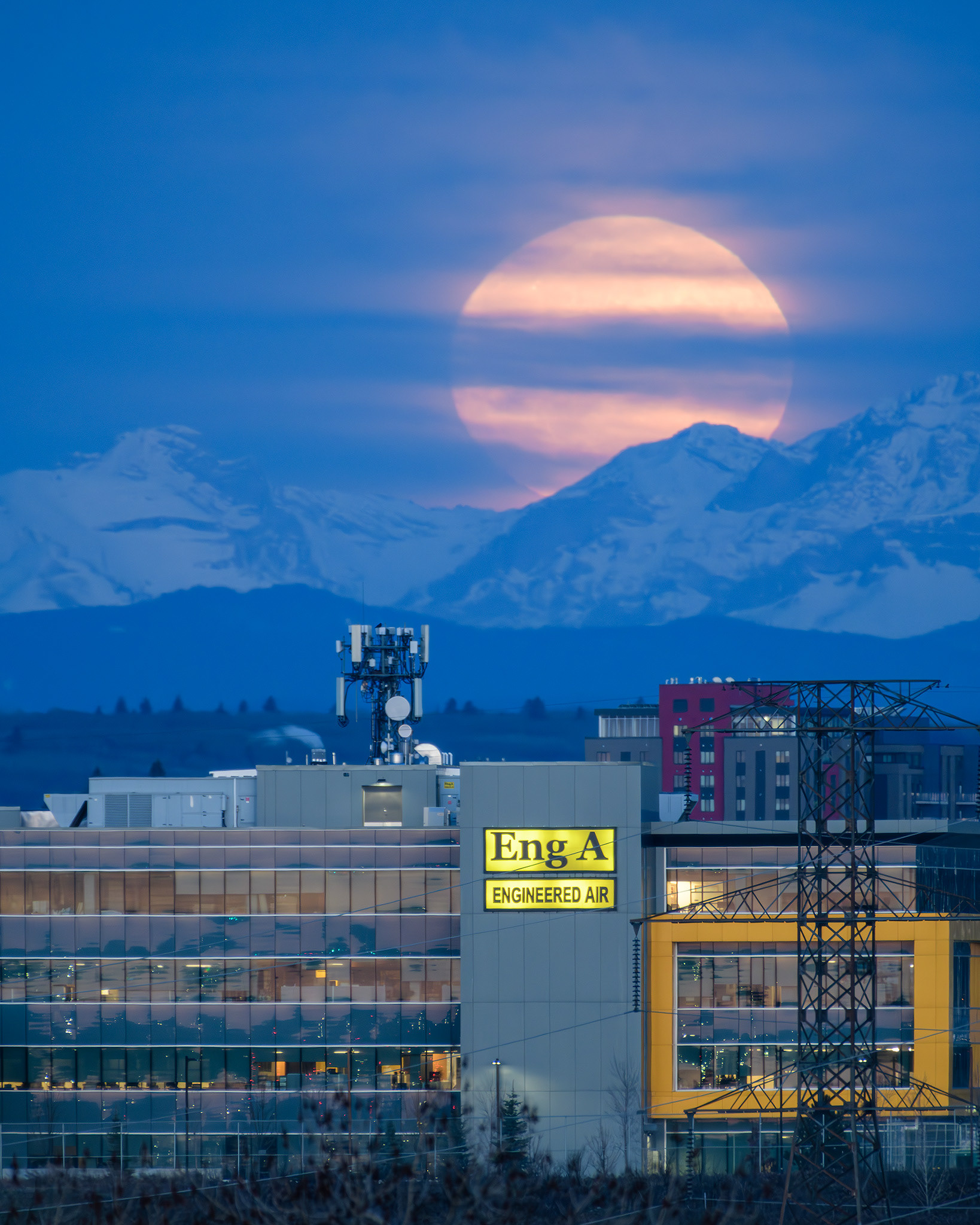 A photo of the Moon setting beyond the Rocky Mountains during Civil Twilight, from Southview Off Leash Dog Park, Calgary, AB - April 23rd