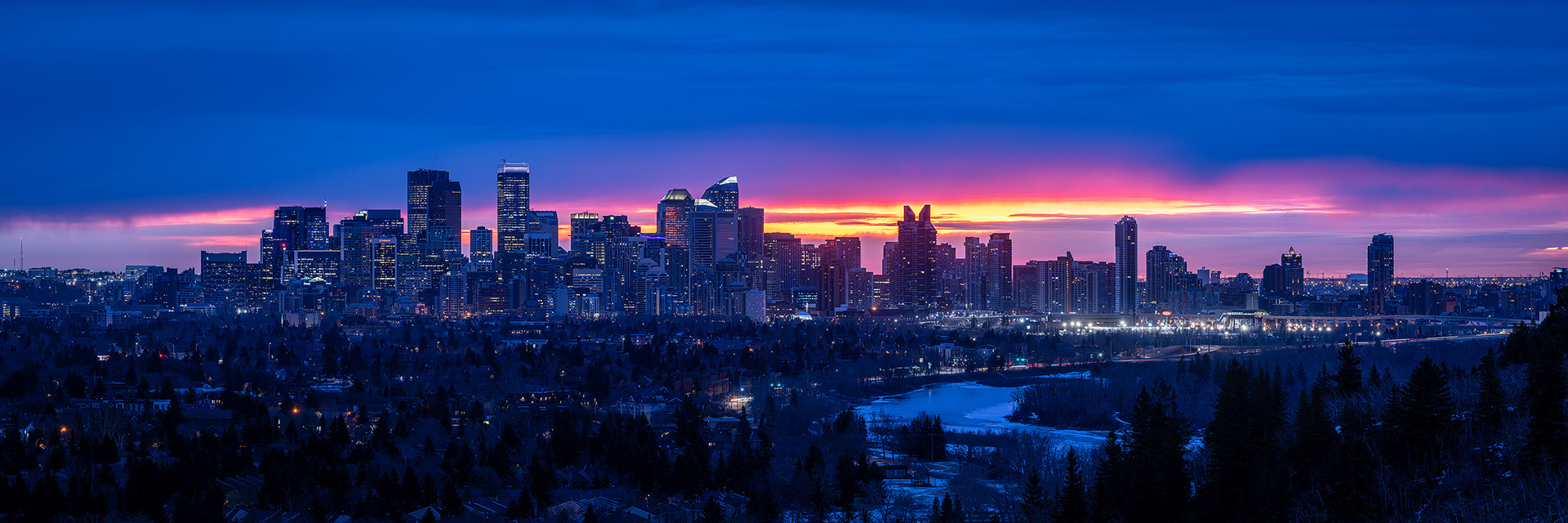 3x1 Panoramic Cityscape (8 shot) of the downtown skyline [pre sunrise, Civil Twilight (sun altitude -4.8 degrees)] from Edworthy Park, Calgary, AB