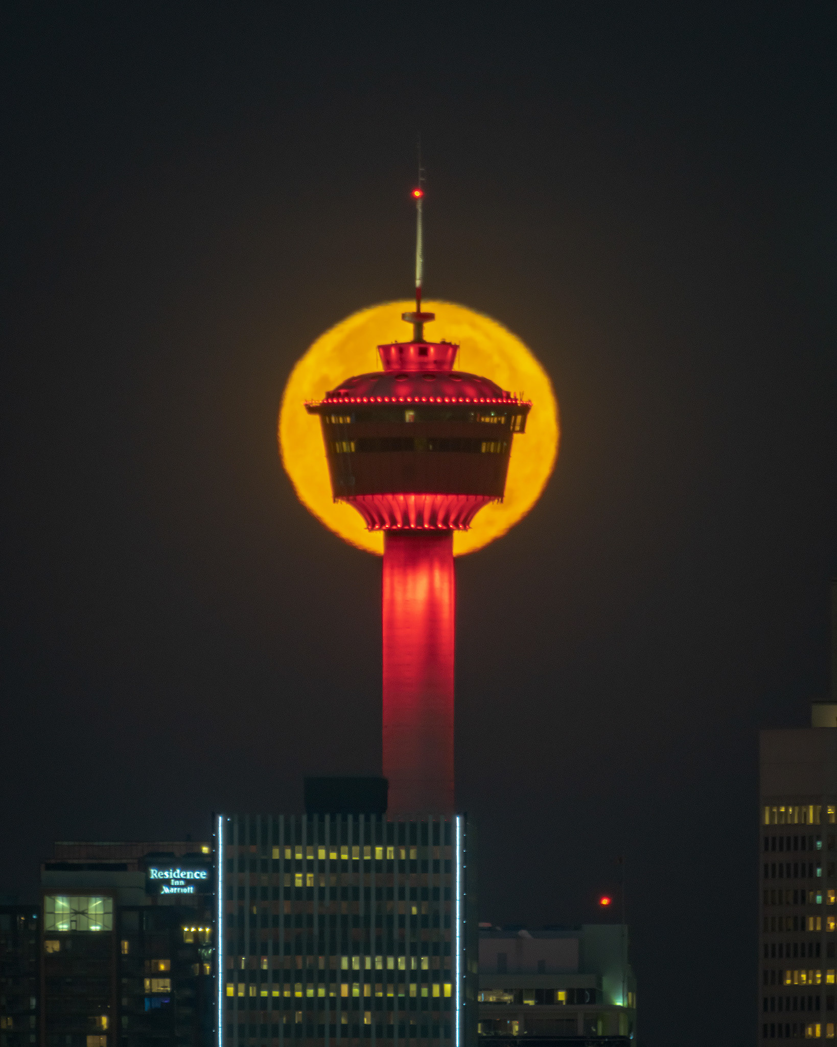 The Calgary Tower and setting Hunter's Moon, from near Max Bell Centre, Calgary, AB - October 9th, 2022 (7:07 AM, 25 Mp)