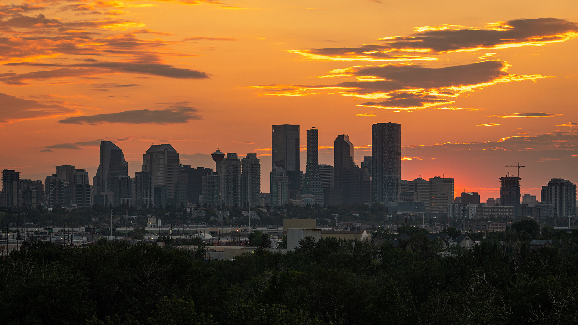 16x9 Cityscape of the downtown skyline at Sunset, from Southview Off Leash Dog Park, Calgary, AB