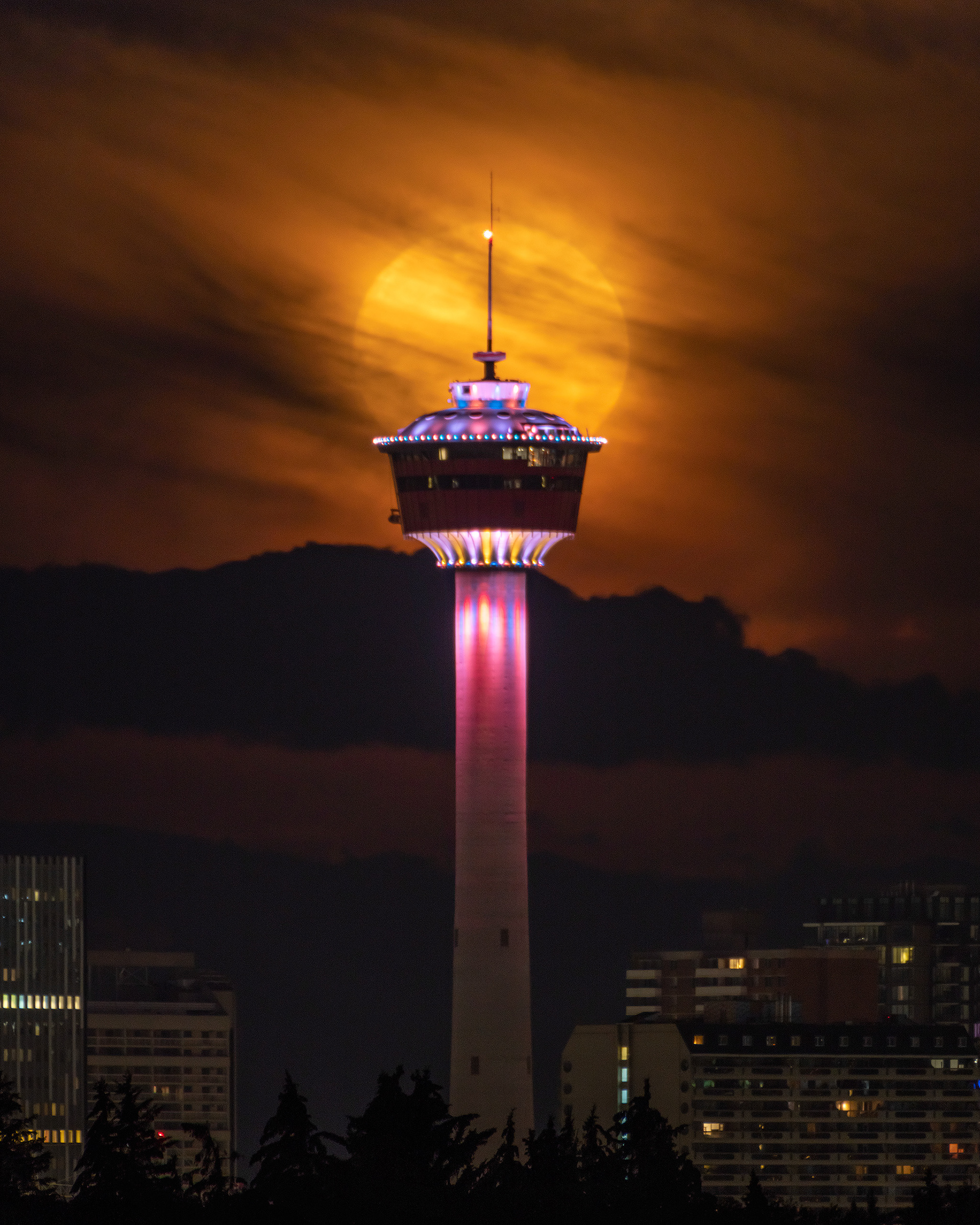 Full Sturgeon Moonset aligned with the Calgary Tower, from Vista Heights Vista, NE Calgary, AB