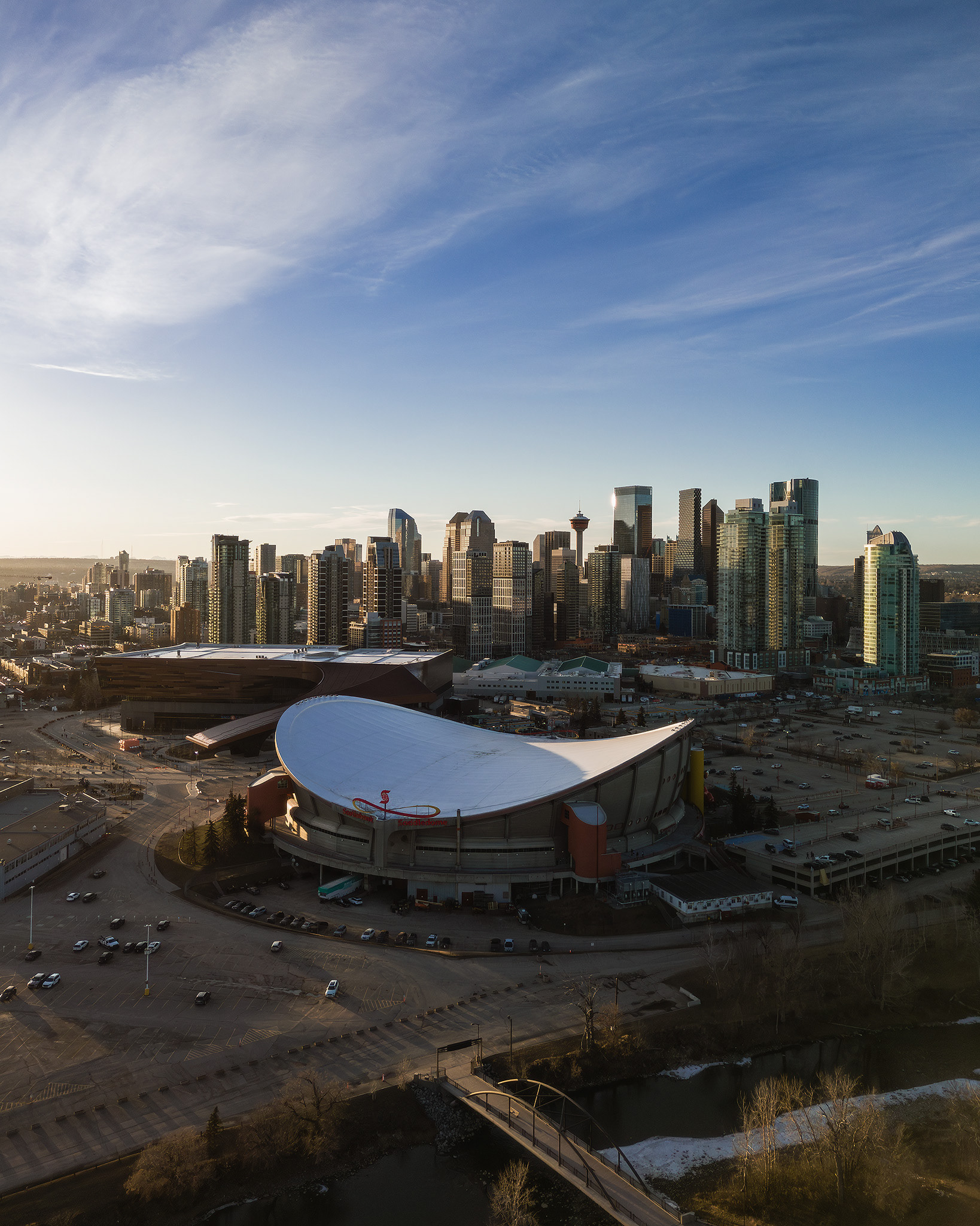 A photo of the Scotiabank Saddledome, with the Downtown Calgary skyline in the background, from near Scotsman's Hill, Calgary, AB - March 17th