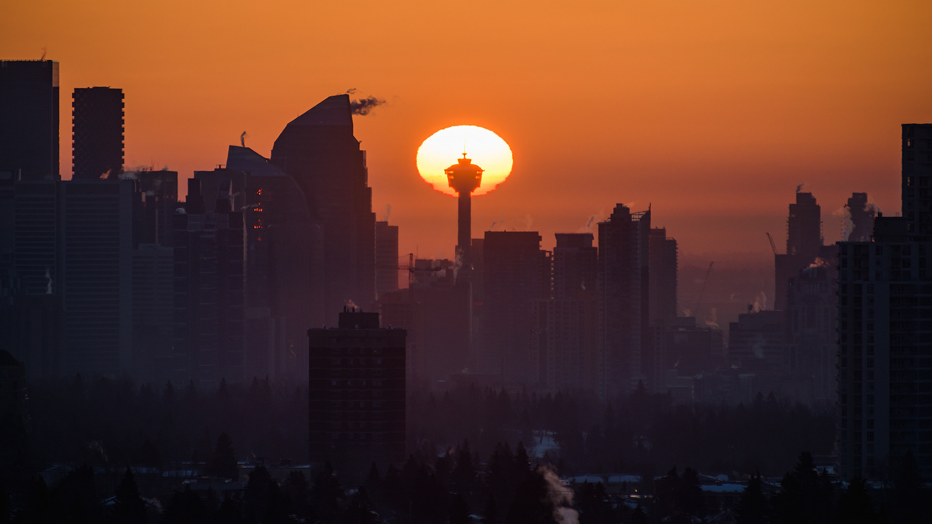 A photo of a portion of the Downtown Calgary skyline at Sunrise, from a park in Strathcona, Calgary, AB - March 20th (7:41 AM, 38 Mp, 16:9 crop)